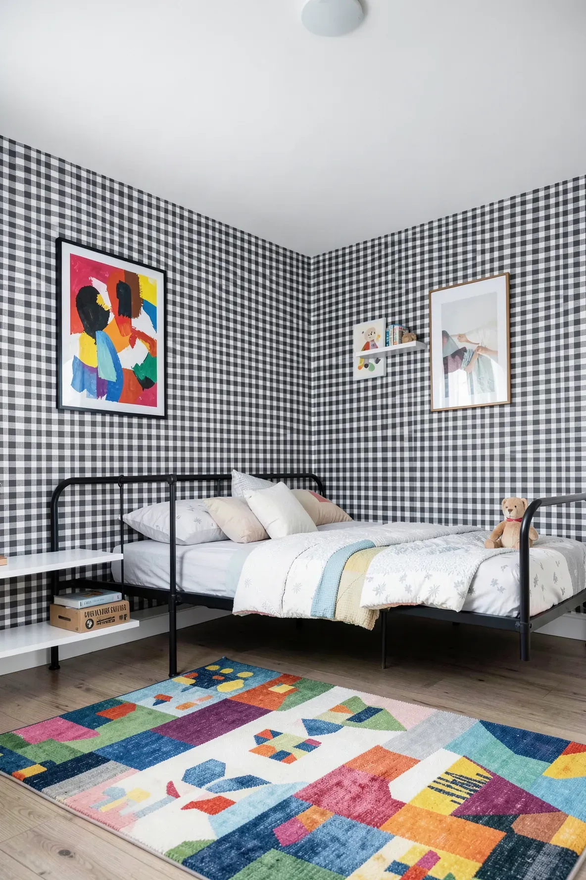 Modern nursery with high-contrast charcoal and white gingham wallpaper and minimalist decor.