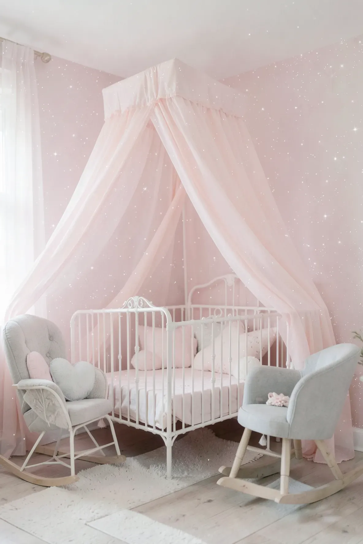 Dreamy nursery with soft pastel pink wallpaper and tiny white speckled dots.