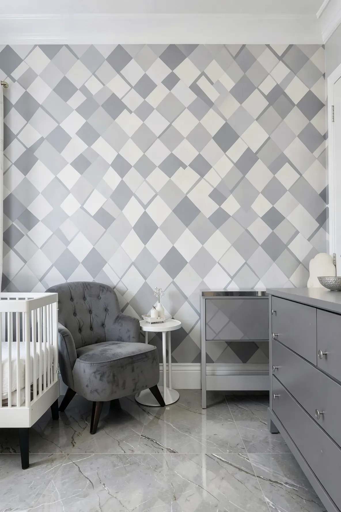 A sophisticated nursery with a cool grey and white harlequin diamond pattern on the main wall.