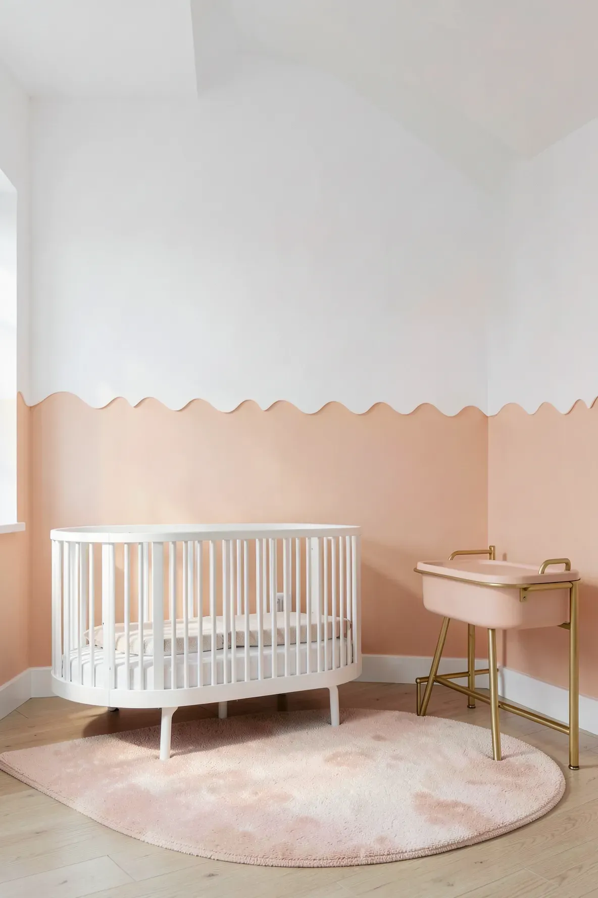 A nursery wall with a peach-colored bottom half and a decorative scalloped edge meeting the white top.