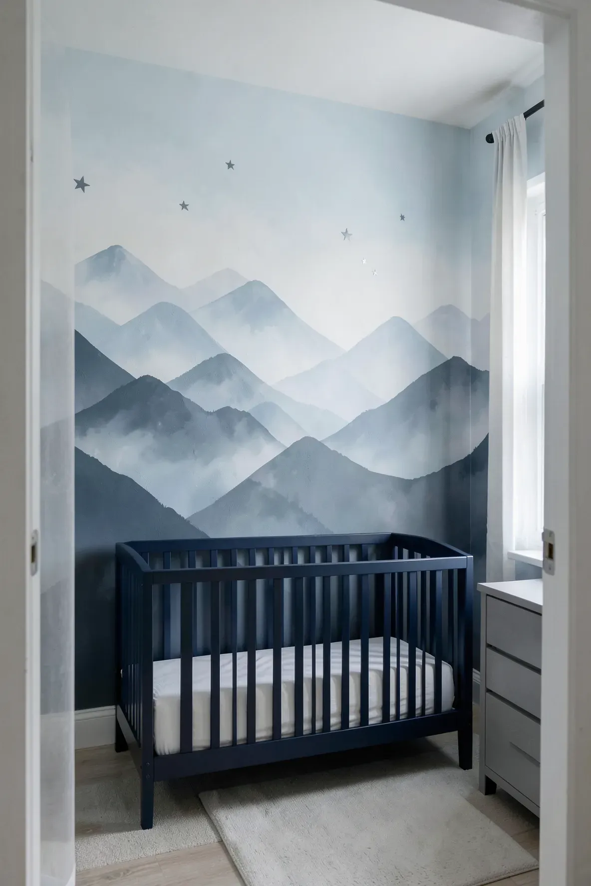 An abstract mountain range mural in shades of blue and white on a nursery wall.