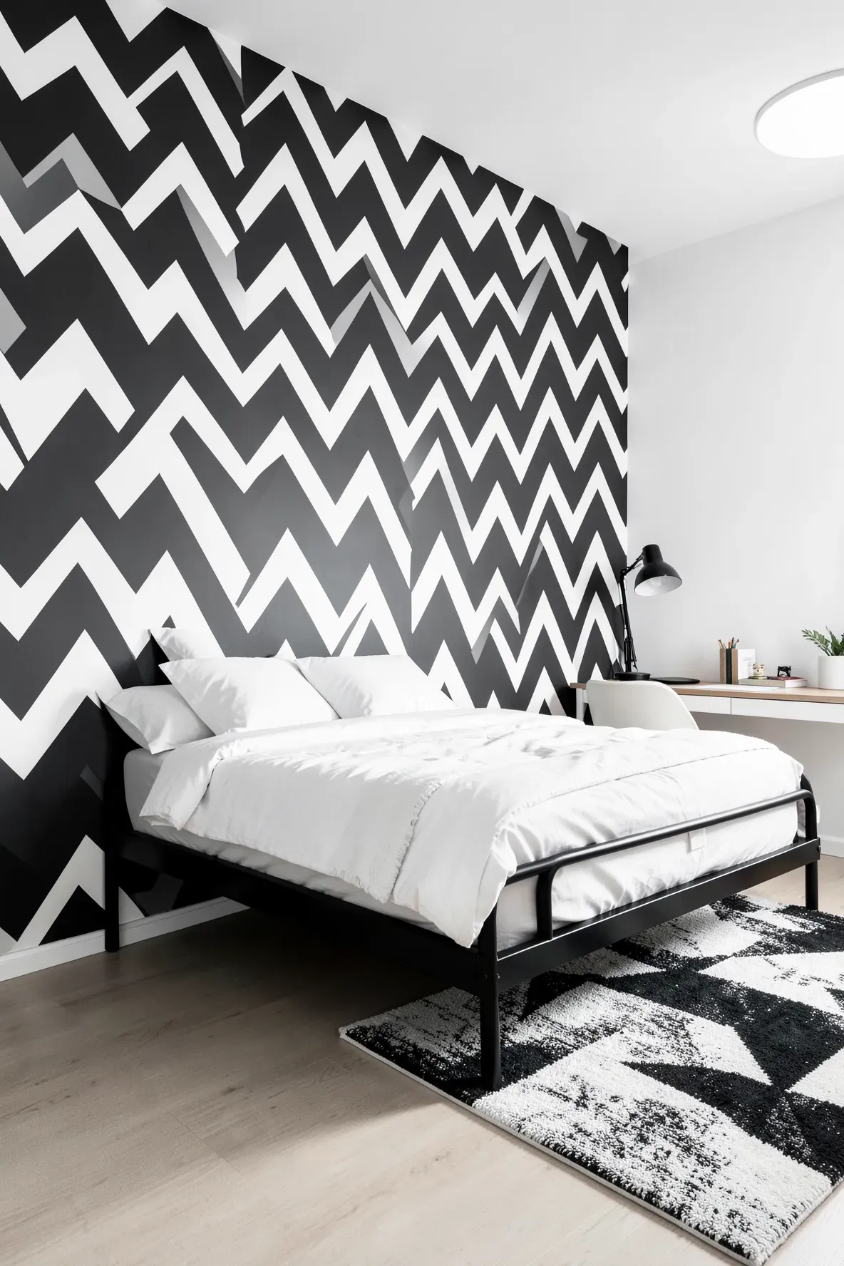 A bold dark grey and white chevron pattern on a modern kids' bedroom accent wall.