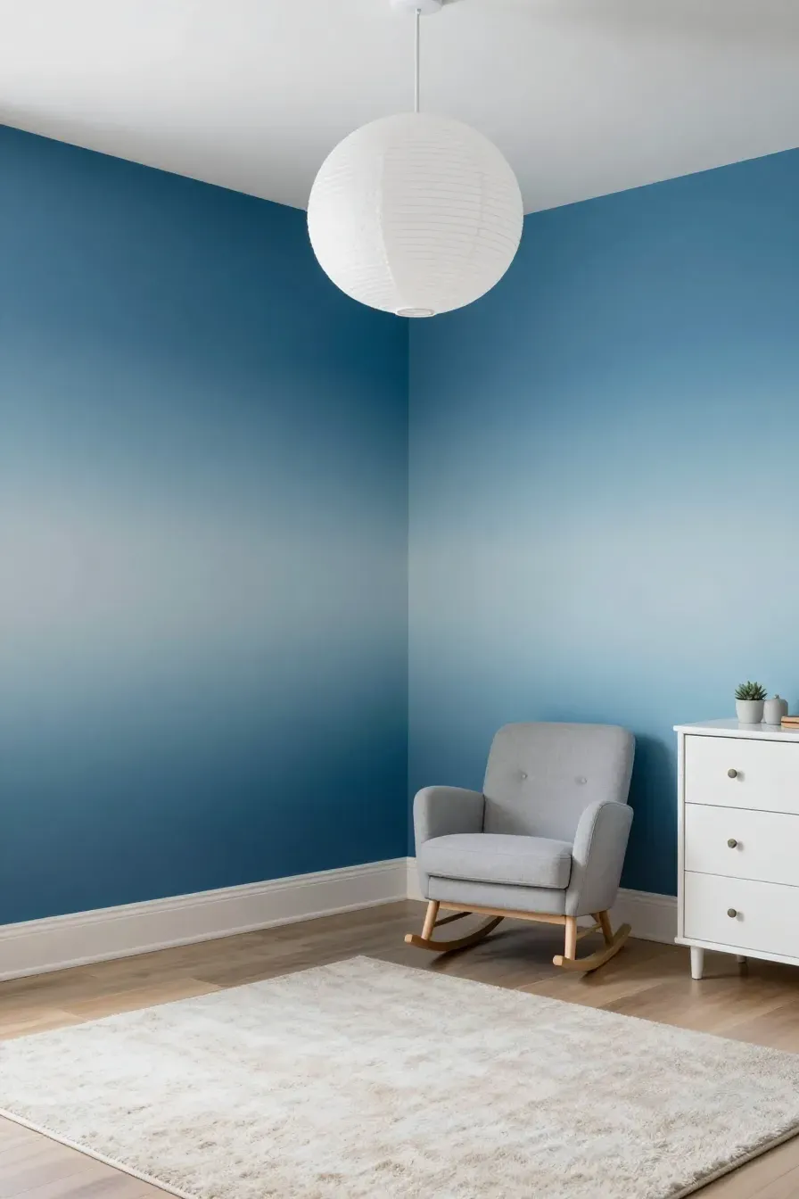 A nursery with walls painted in a blue ombre gradient from dark navy to white, creating an ocean effect.