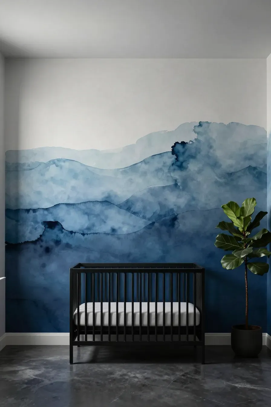 A modern nursery with an abstract blue ink wash gradient mural and a black metal crib.