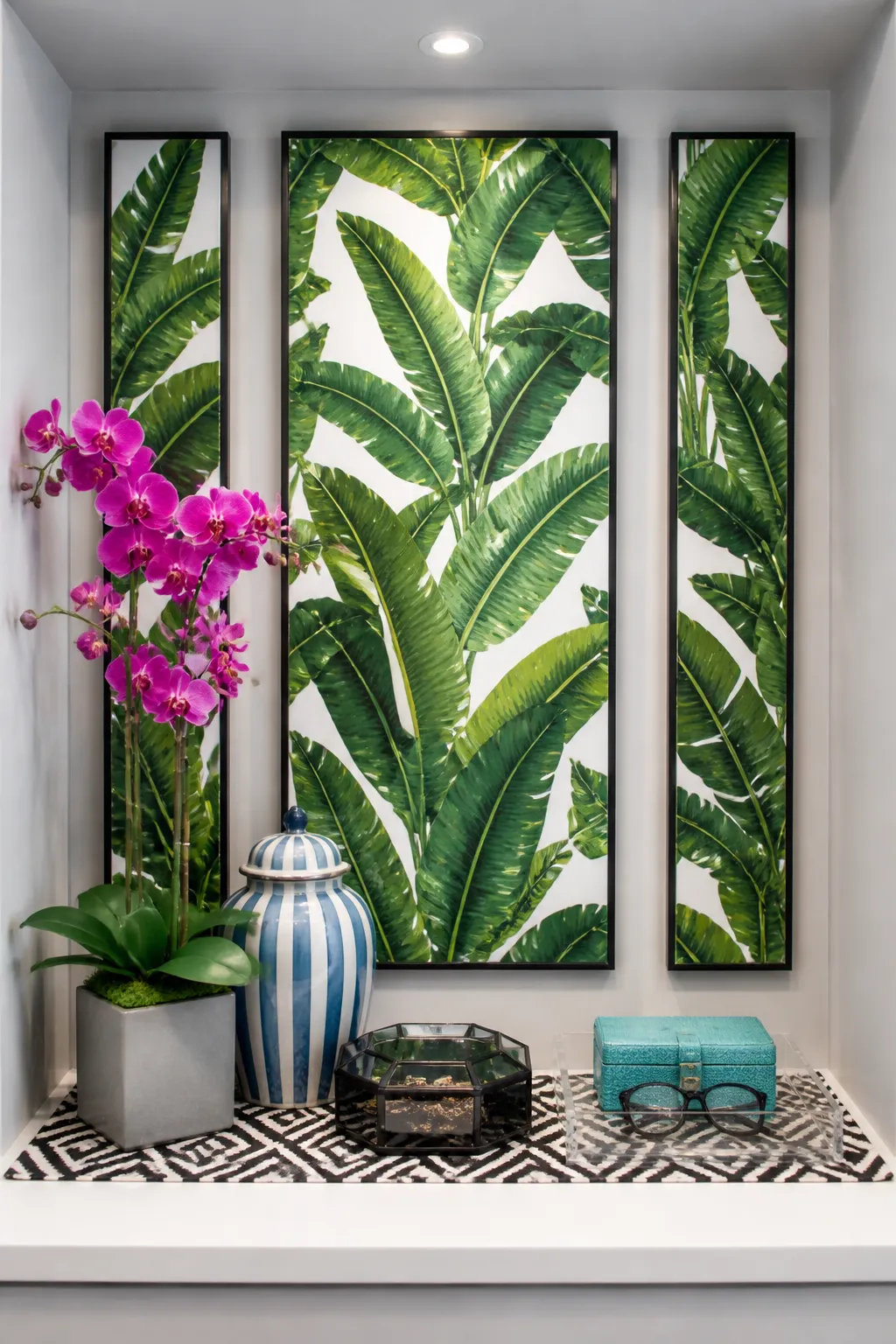 Three framed panels of iconic green banana leaf wallpaper in a gray wall nook.