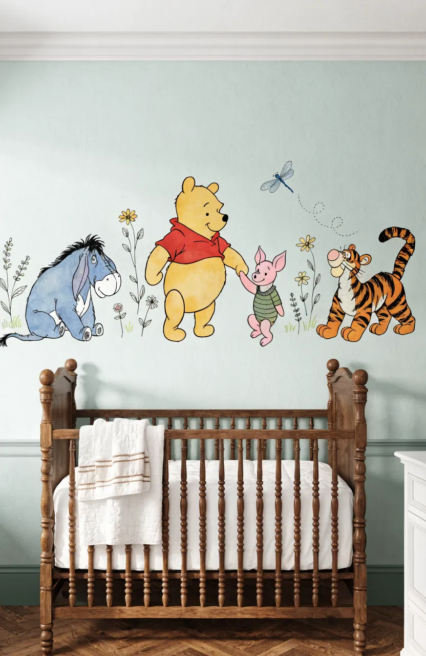 Pale sage green wall with classic storybook animal illustrations like a bear and donkey above a dark wood crib.