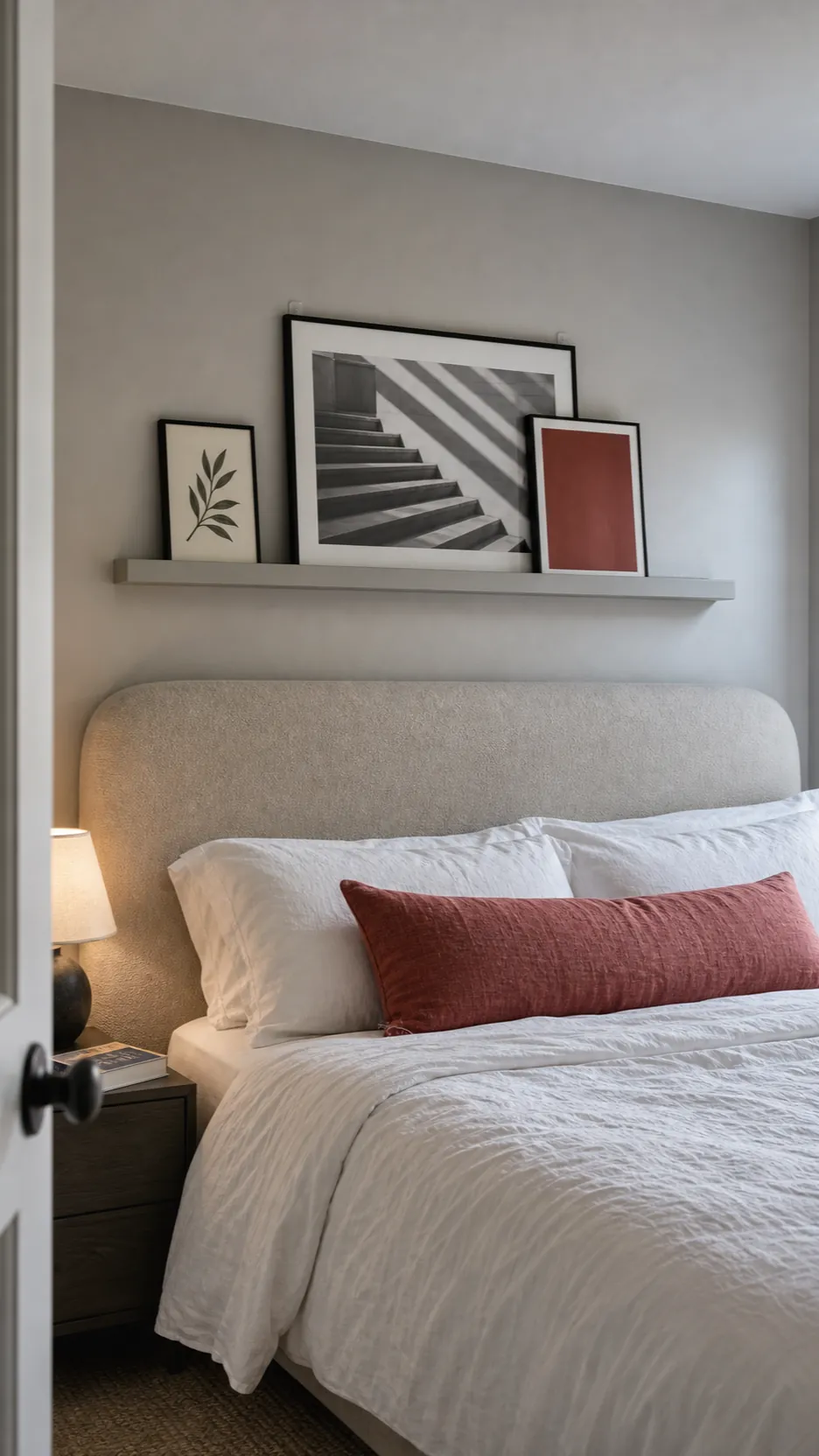 Lightweight frames secured on a slim picture ledge above a padded bedroom headboard