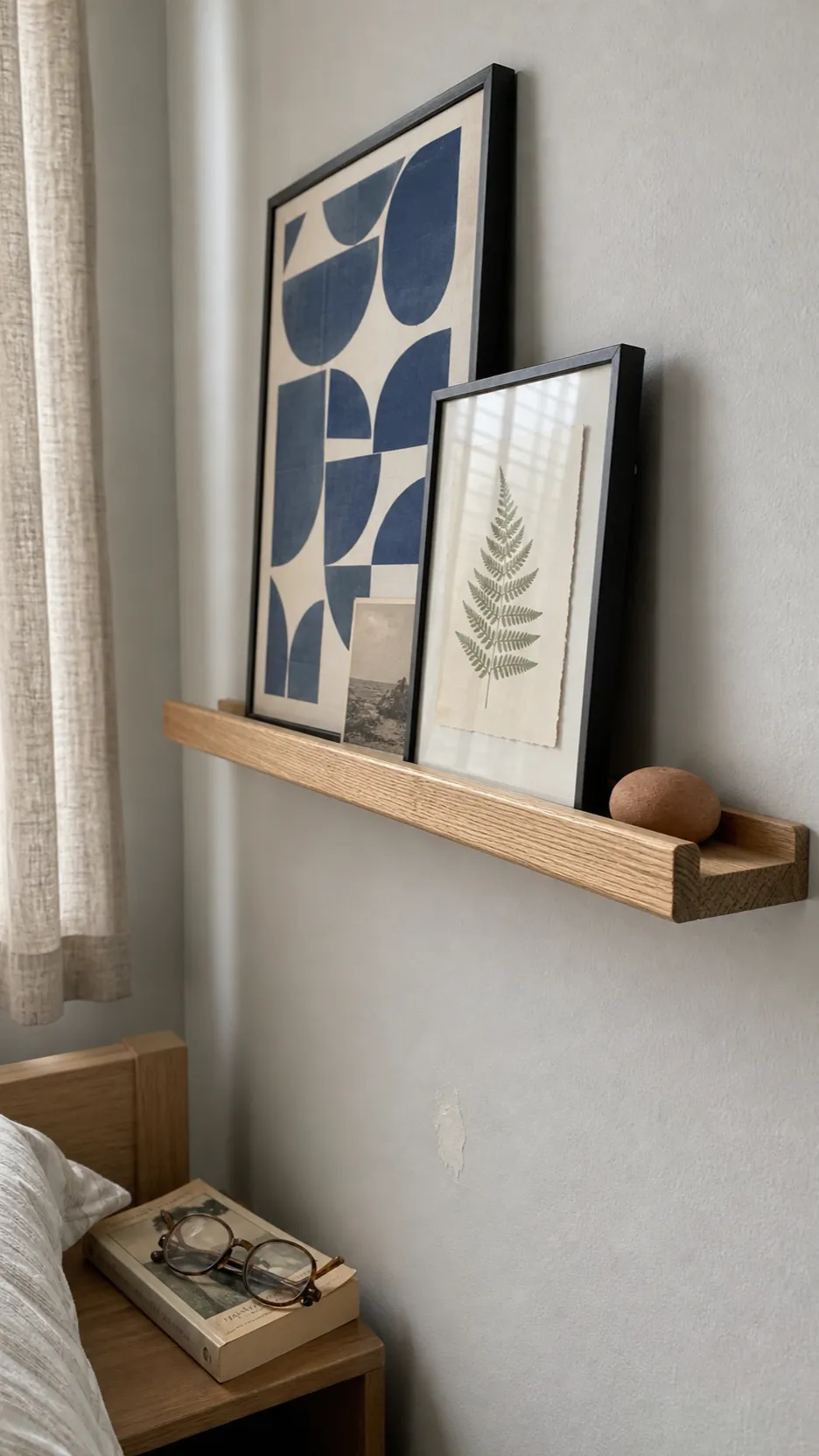 Close view of a shallow oak picture ledge sized for lightweight bedroom frames