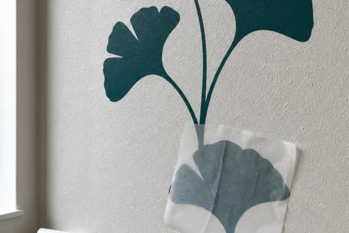 Modern vinyl wall decal adhering to a lightly textured orange peel wall