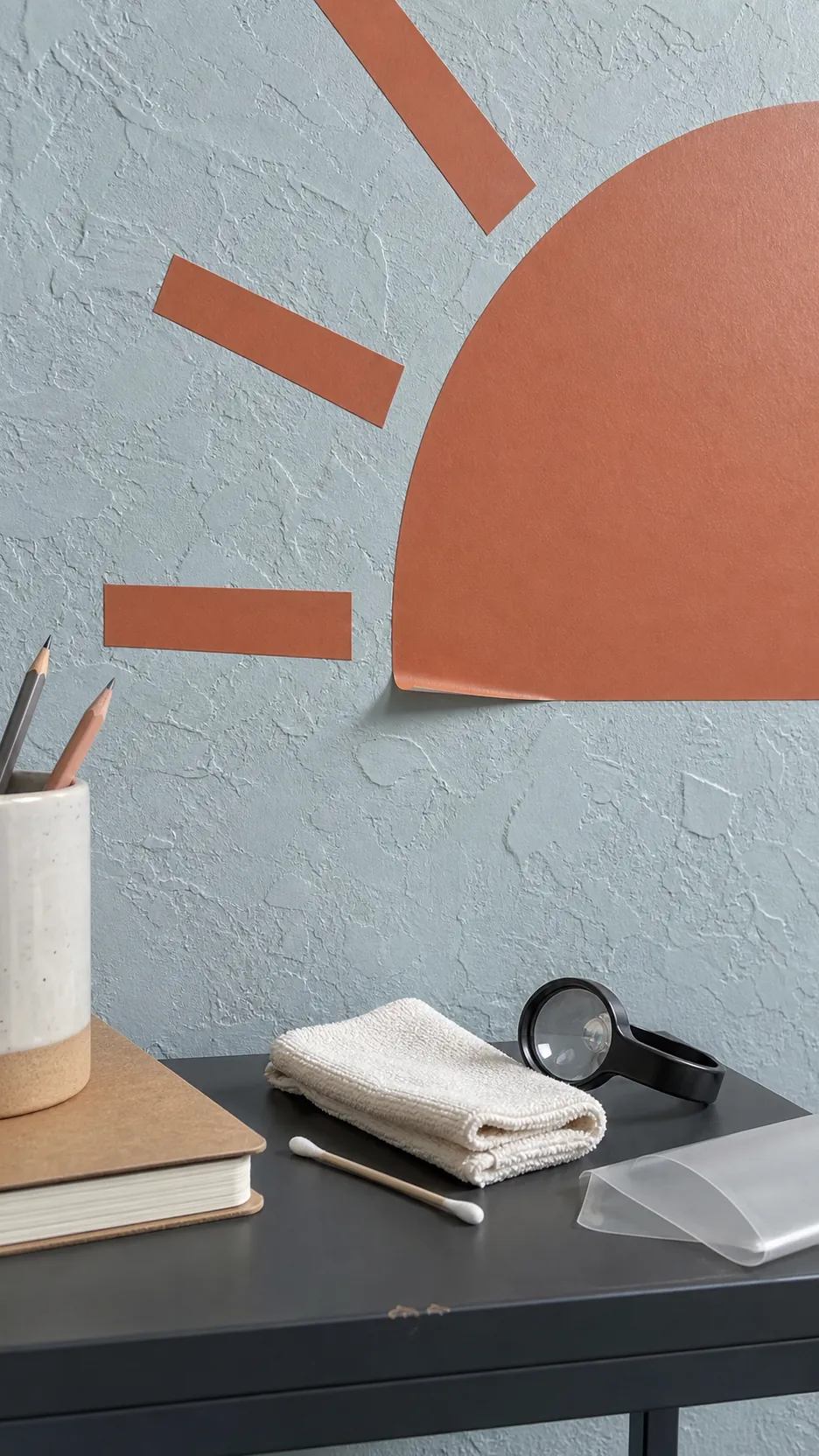 Close inspection of a lifting vinyl decal edge on a knockdown textured wall