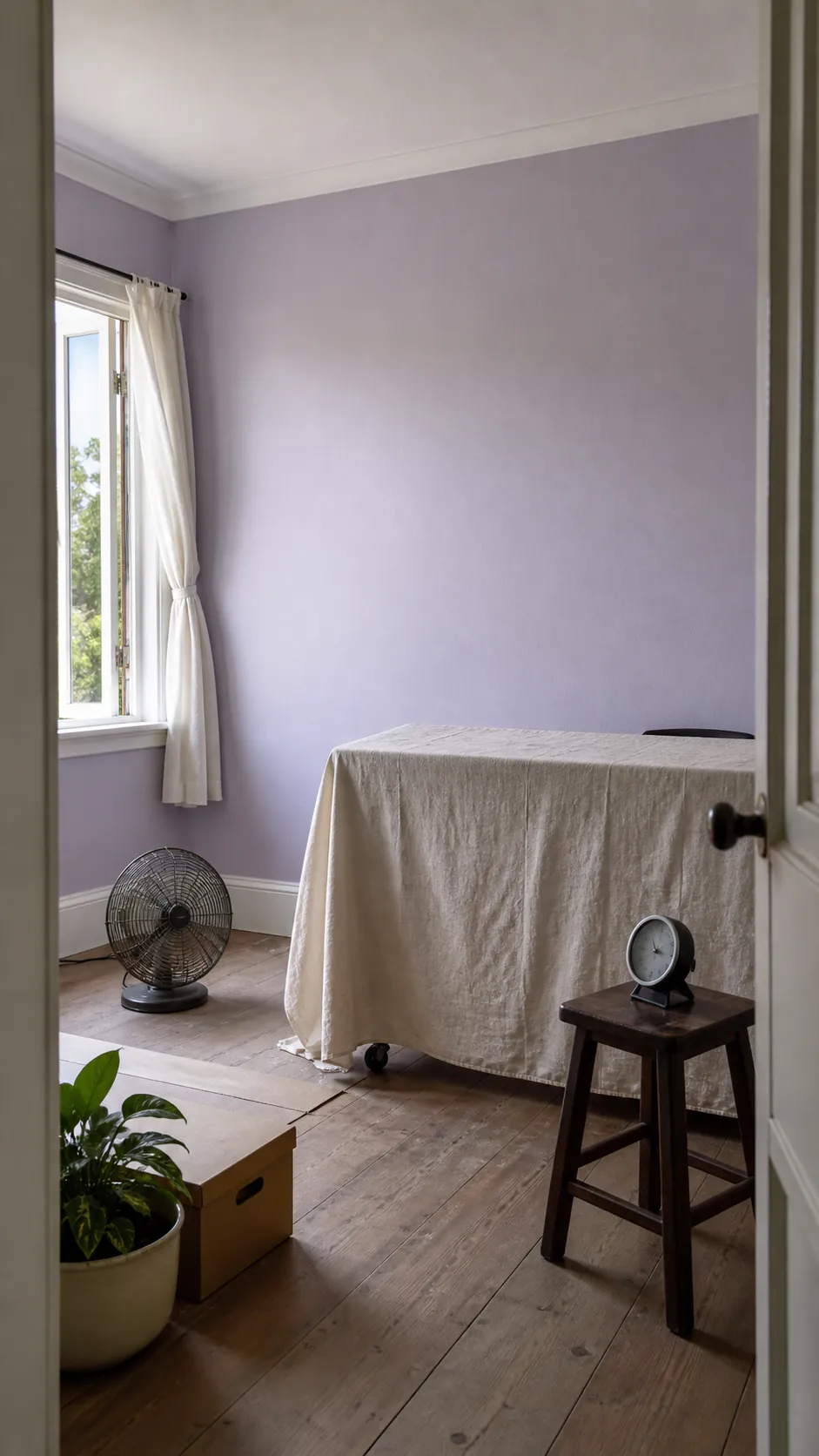 Ventilated freshly painted room with open window, humidity monitor, and clear wall space