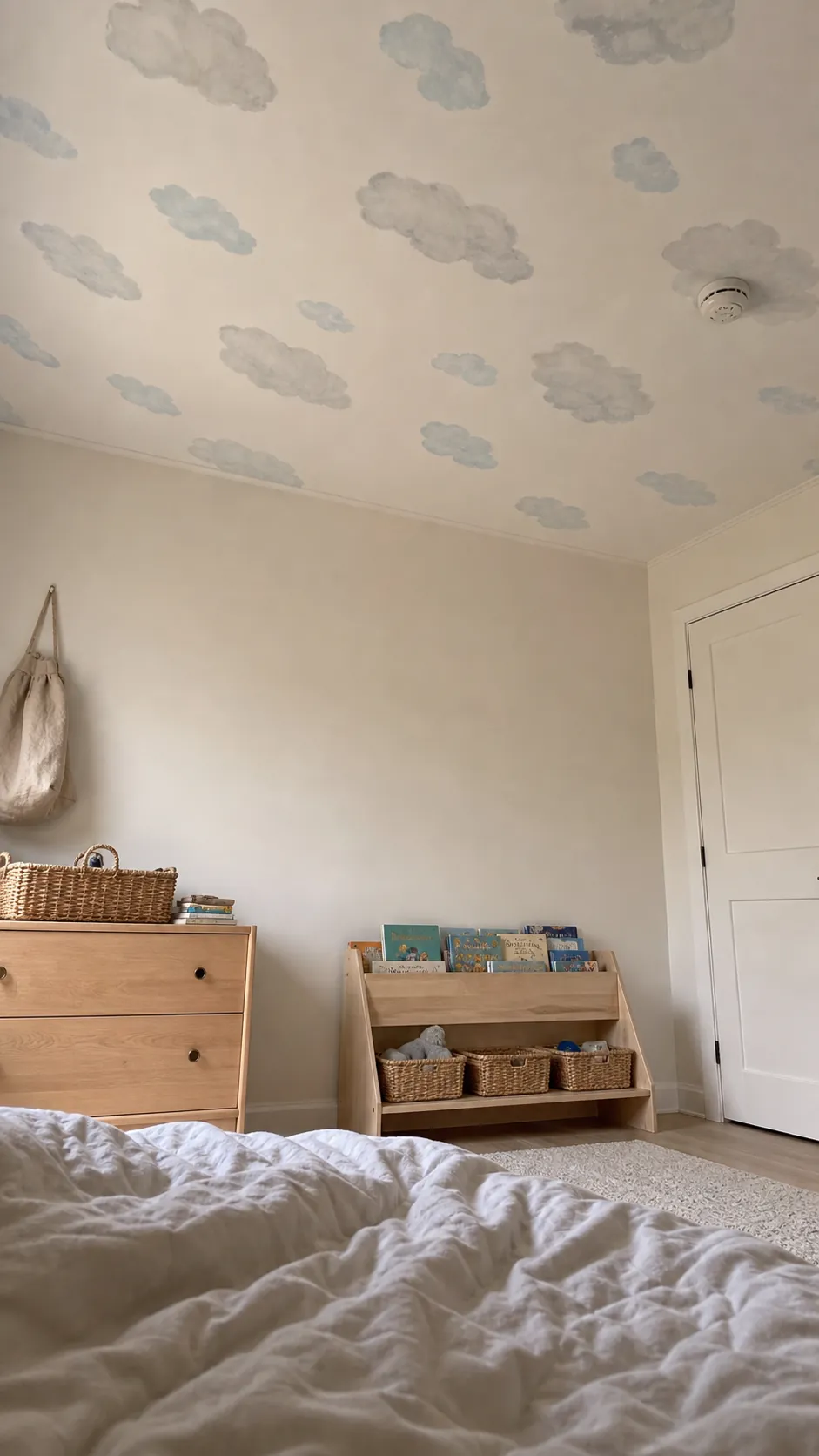 Soft cloud wallpaper installed on a child's bedroom ceiling