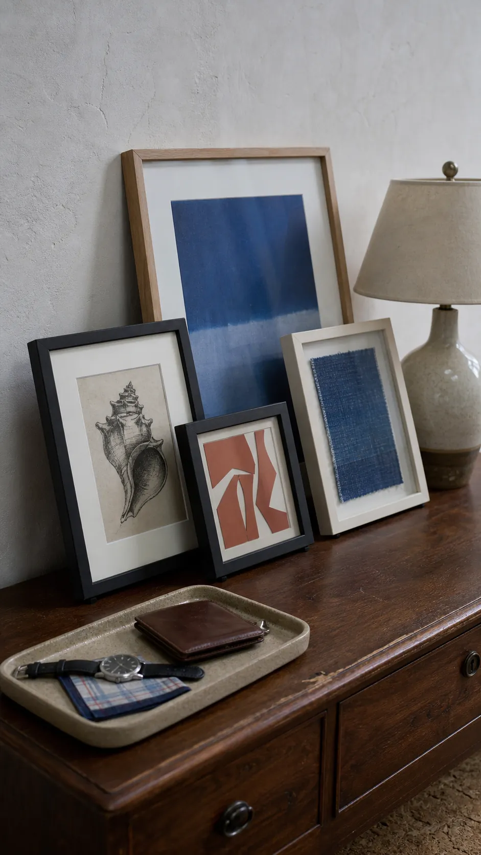 Layered lightweight frames leaning safely on a bedroom dresser