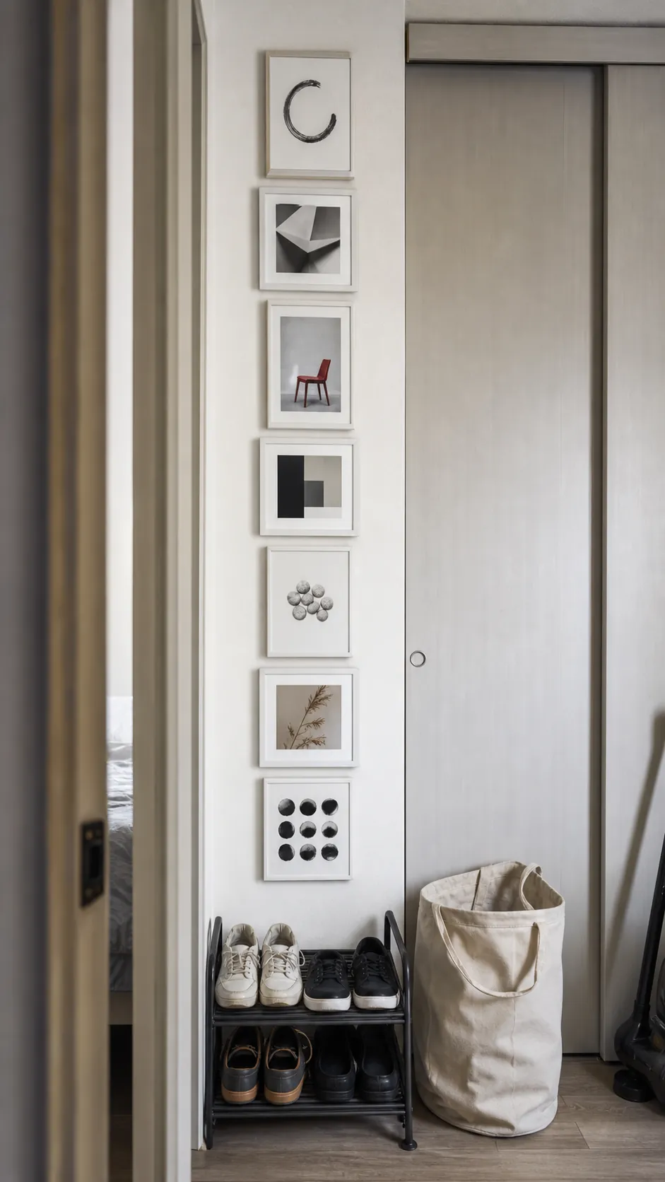 Narrow vertical gallery wall column beside an apartment closet