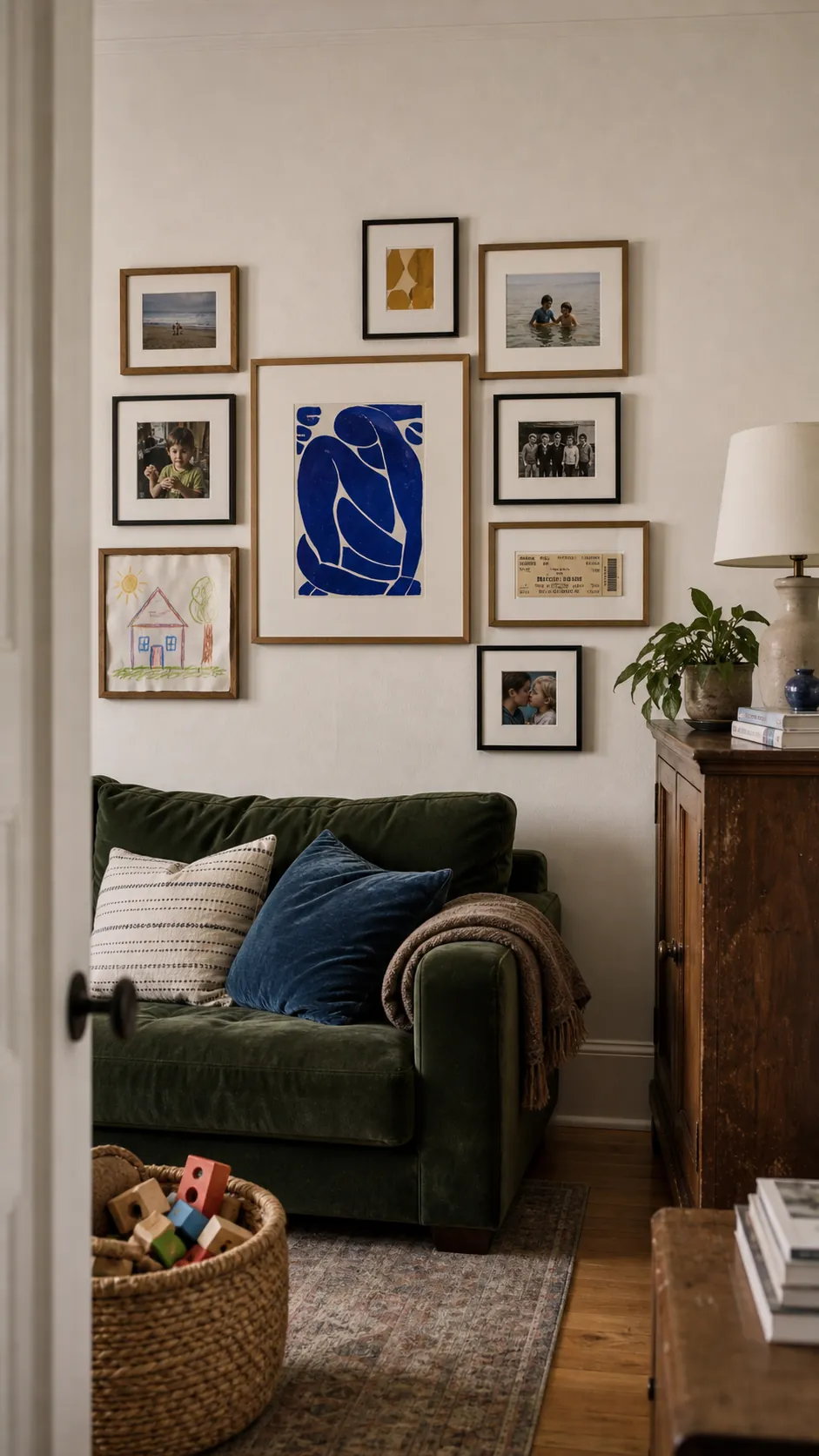 Personal asymmetrical gallery wall with photographs and graphic prints
