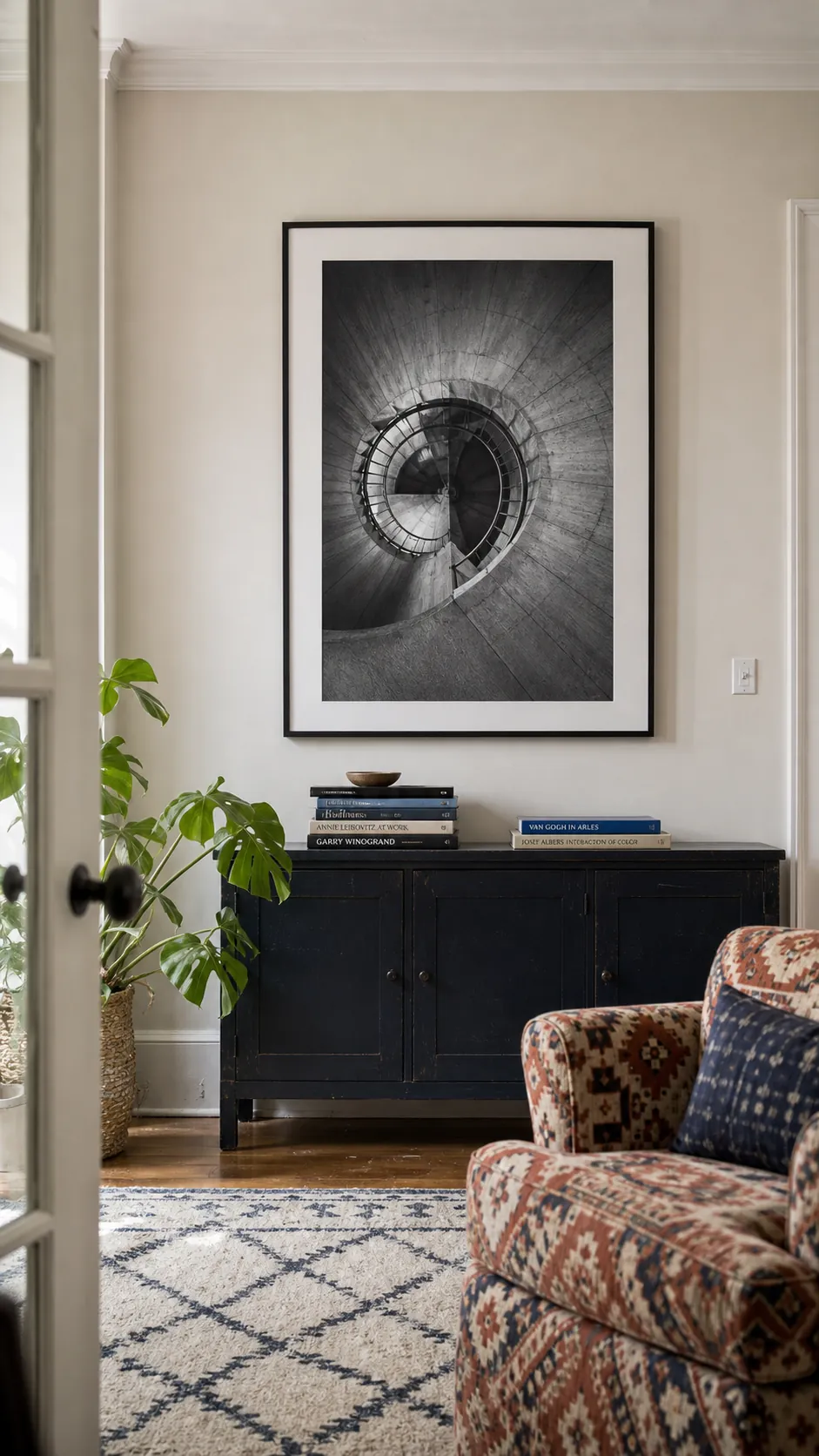 Single black-and-white architectural photograph on a quiet living room wall