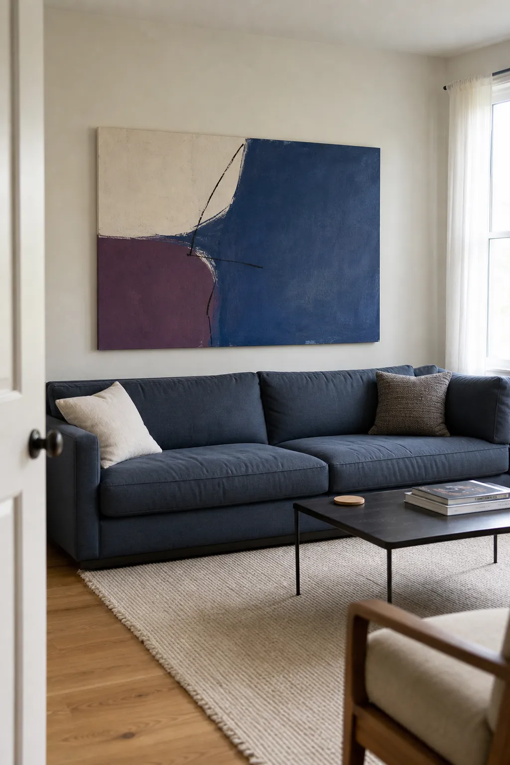 Oversized abstract canvas correctly scaled above a long sofa