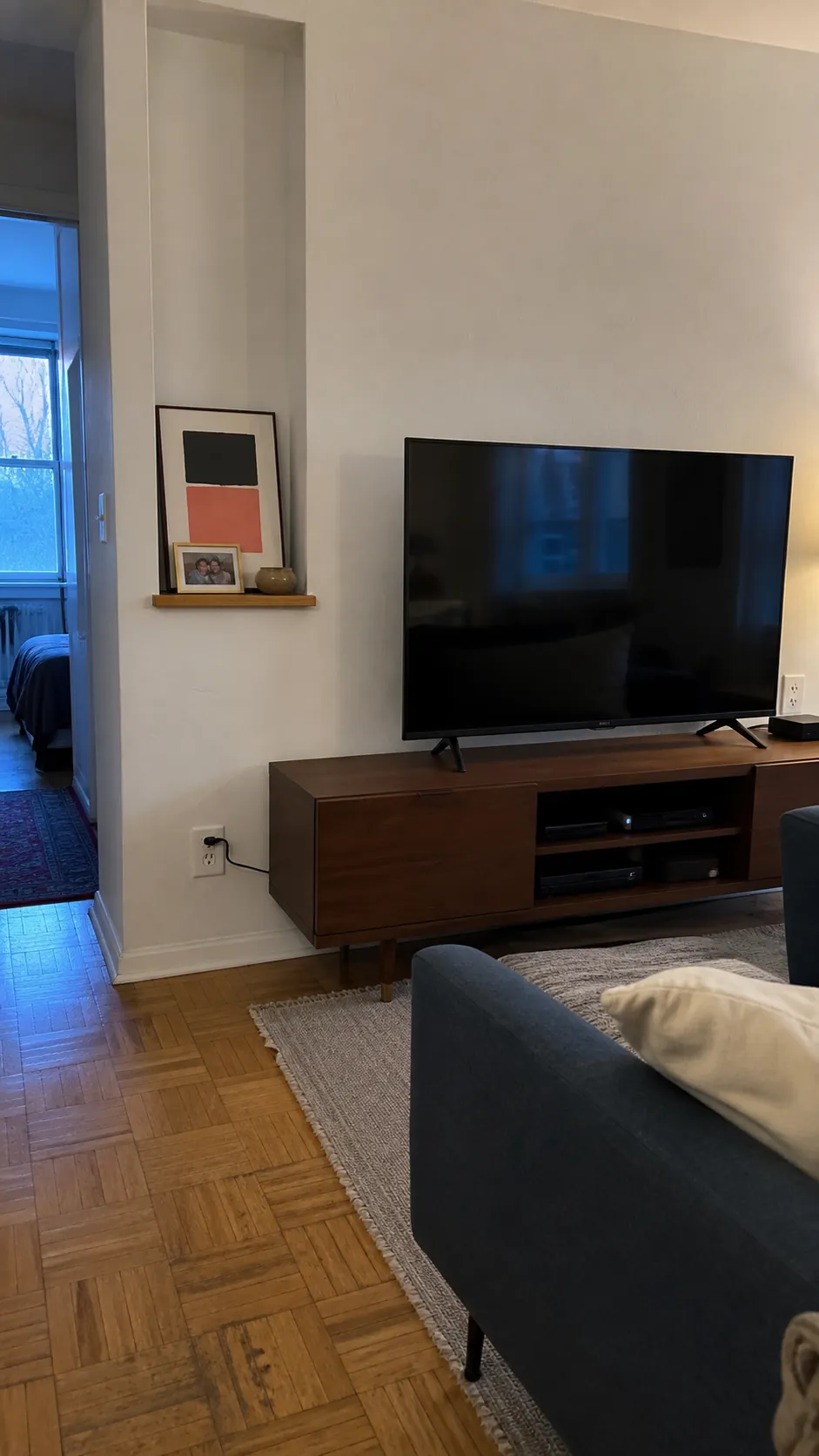 Short picture ledge placed beside rather than above a television