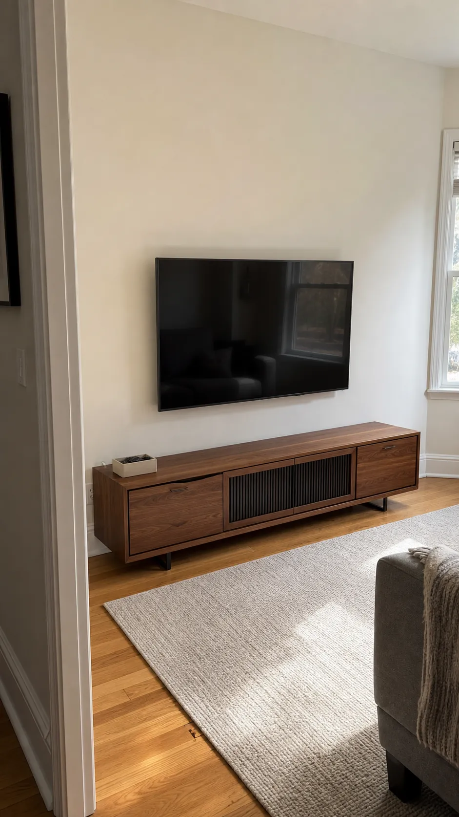 Minimal TV wall with hidden cables and deliberate empty space