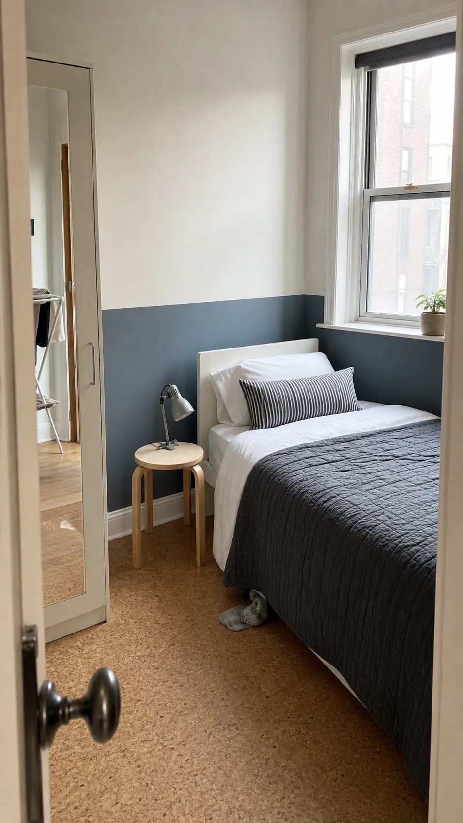Muted blue-gray wainscot style wall decal in a compact bedroom