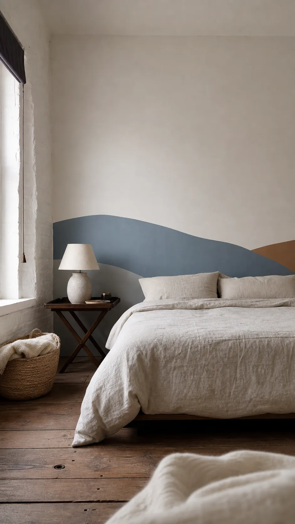 Mineral blue and muted umber abstract horizon decal behind a calm bed