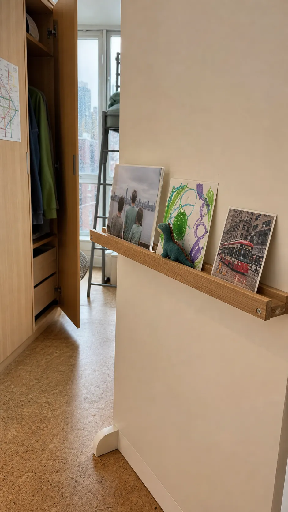 Low personalized photo ledge displaying a child's favorite pictures and art