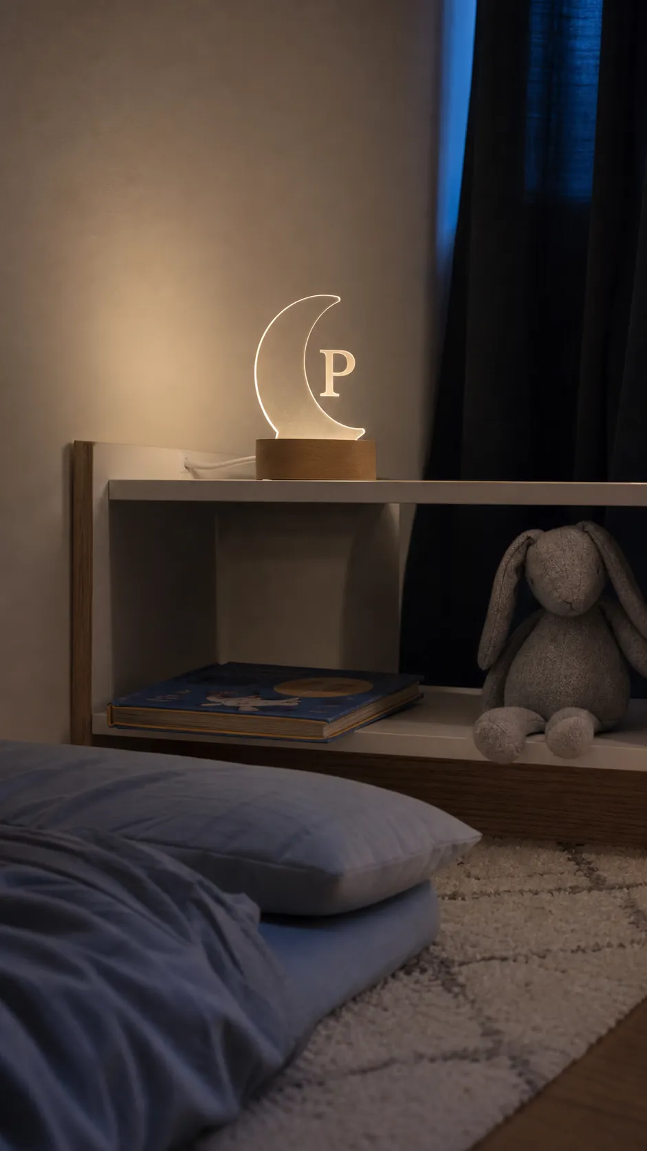 Soft personalized silhouette night light on a child's bedside shelf