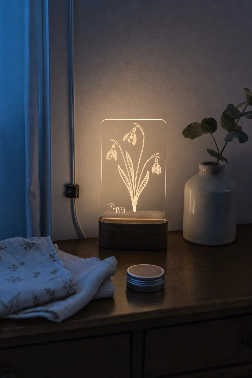 Etched birth flower night light on a nursery dresser