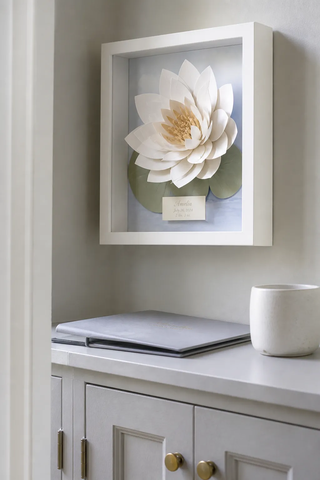 Layered paper birth flower shadow box in a nursery