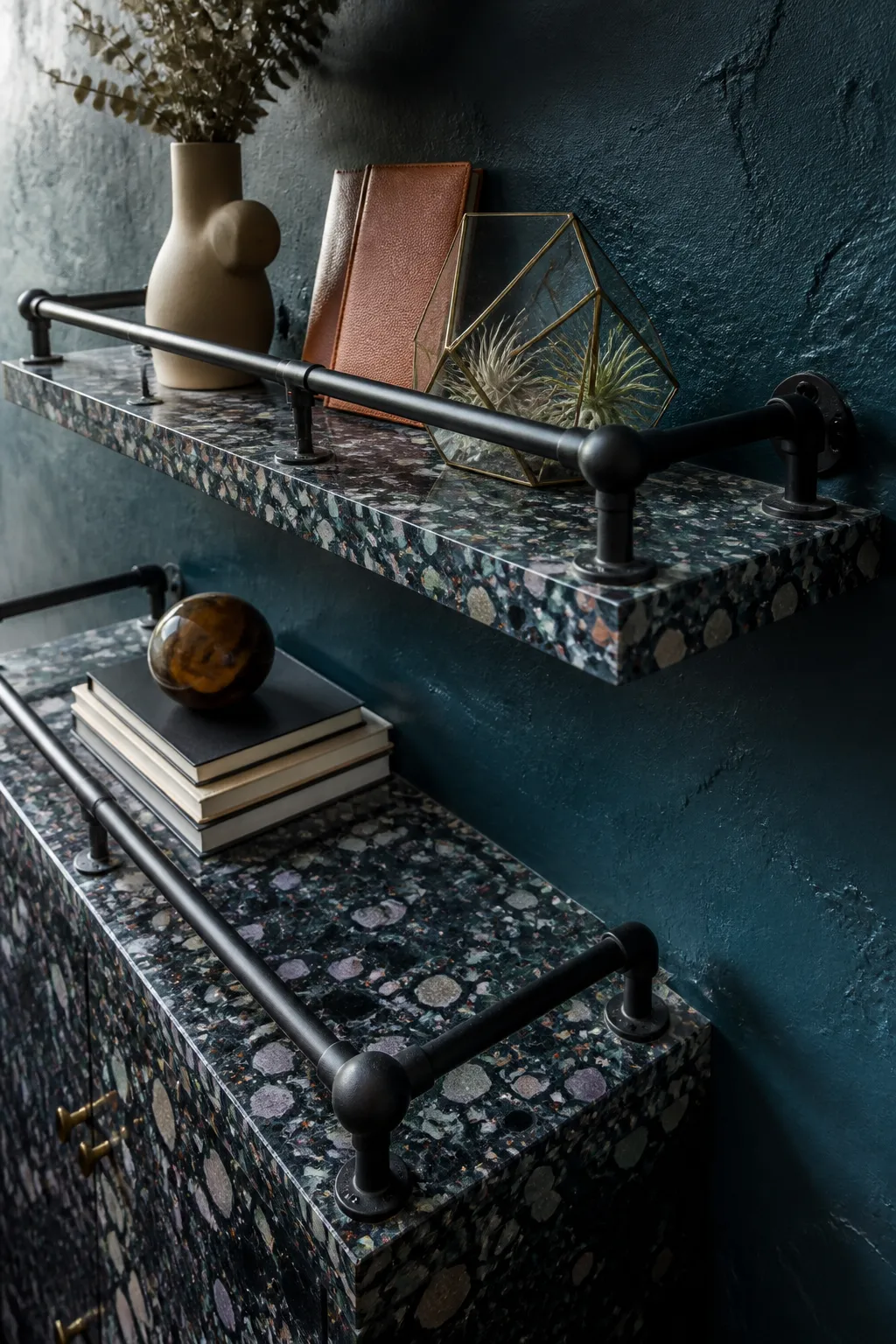 Industrial metal rail shelves set against colorful jewel-tone terrazzo