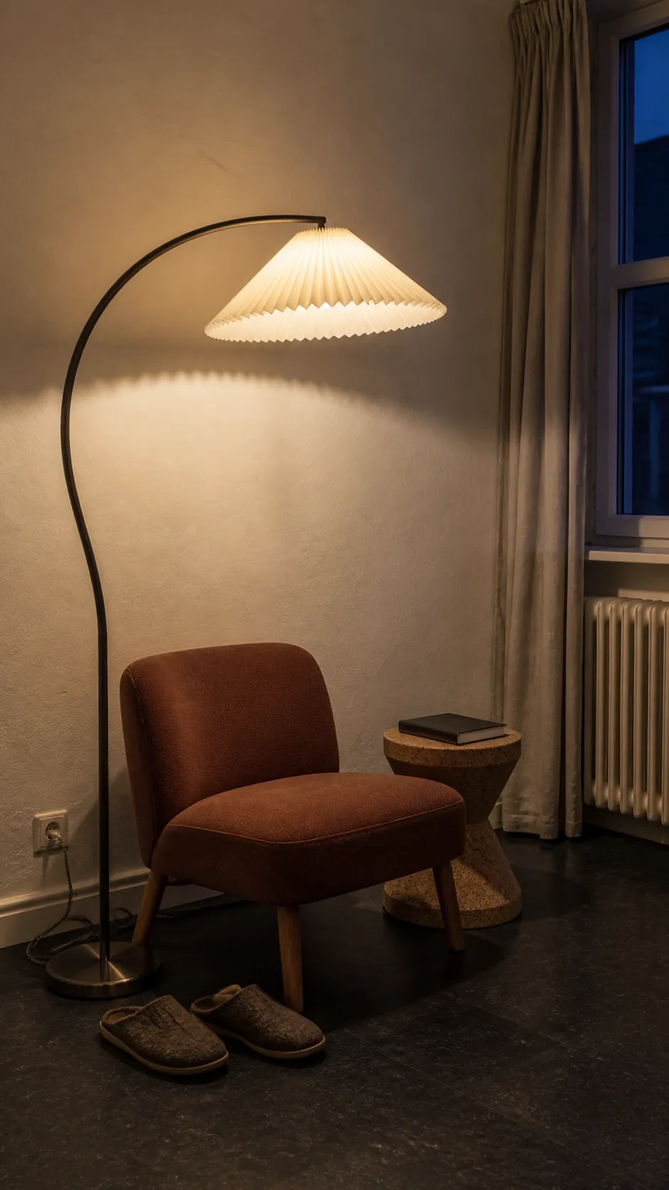 Sculptural floor lamp casting affordable decorative light on a blank wall