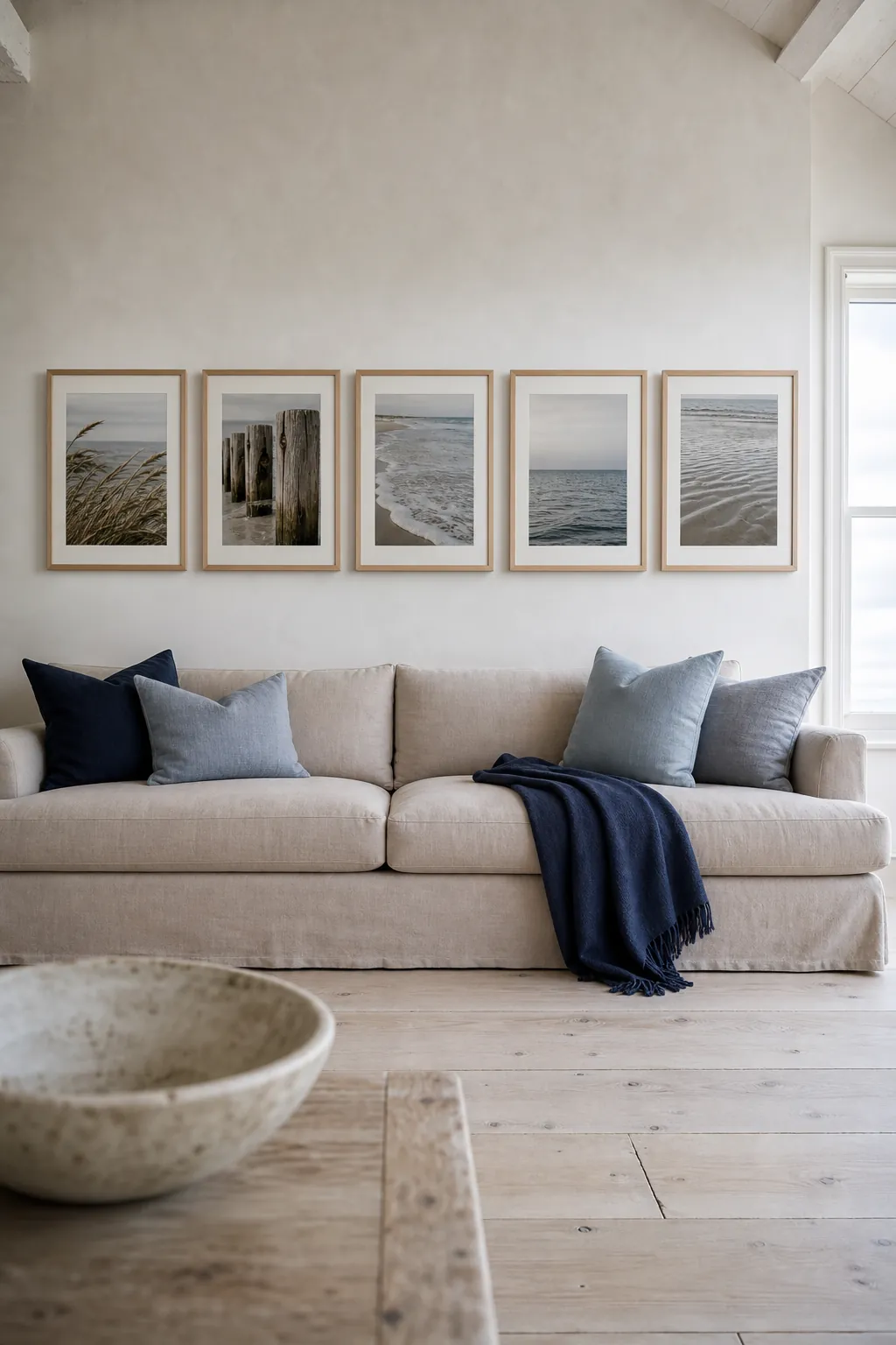 Coastal photography sequence as gallery wall above couch decor