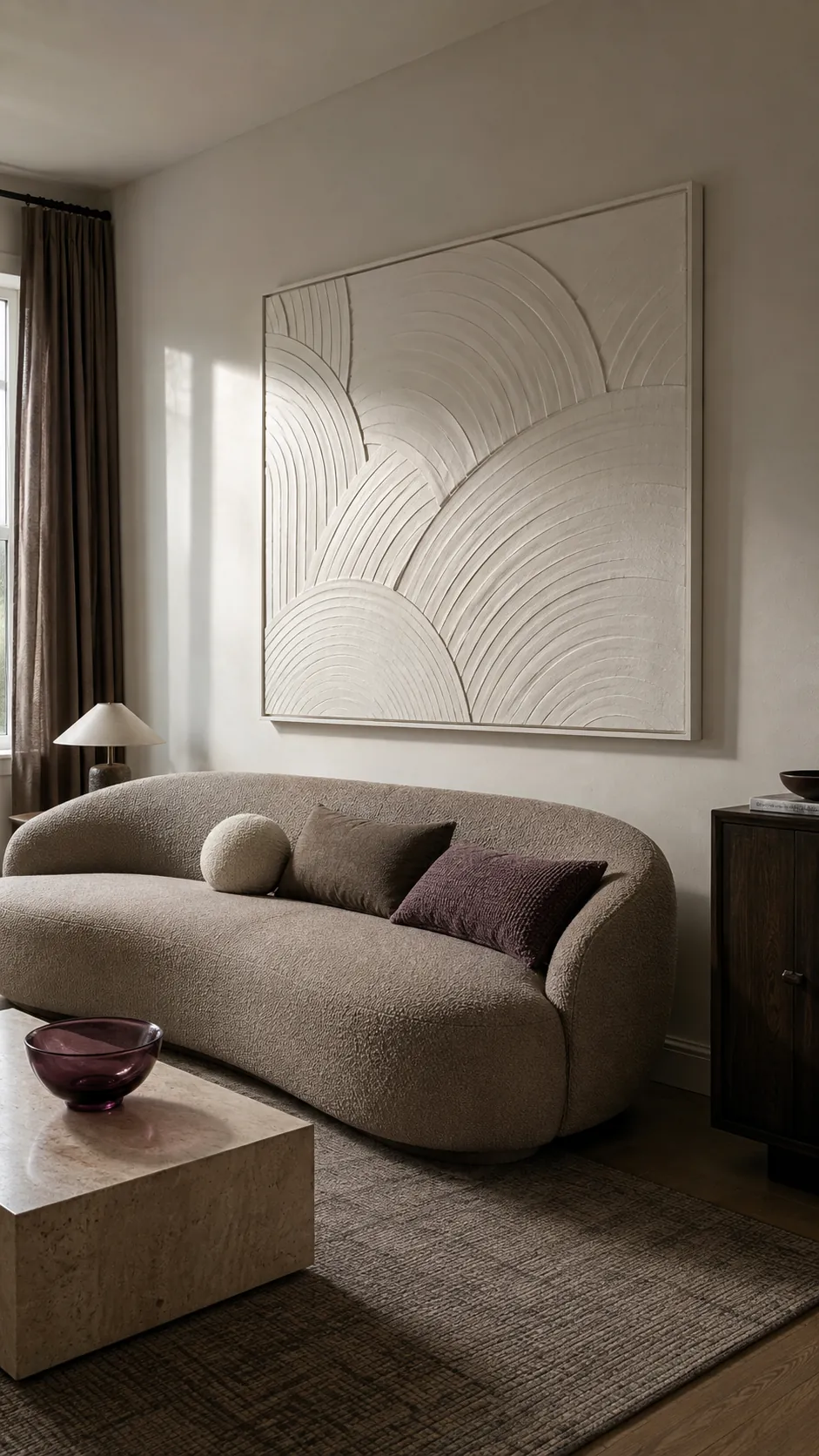 Sculptural plaster relief mounted safely above a curved sofa