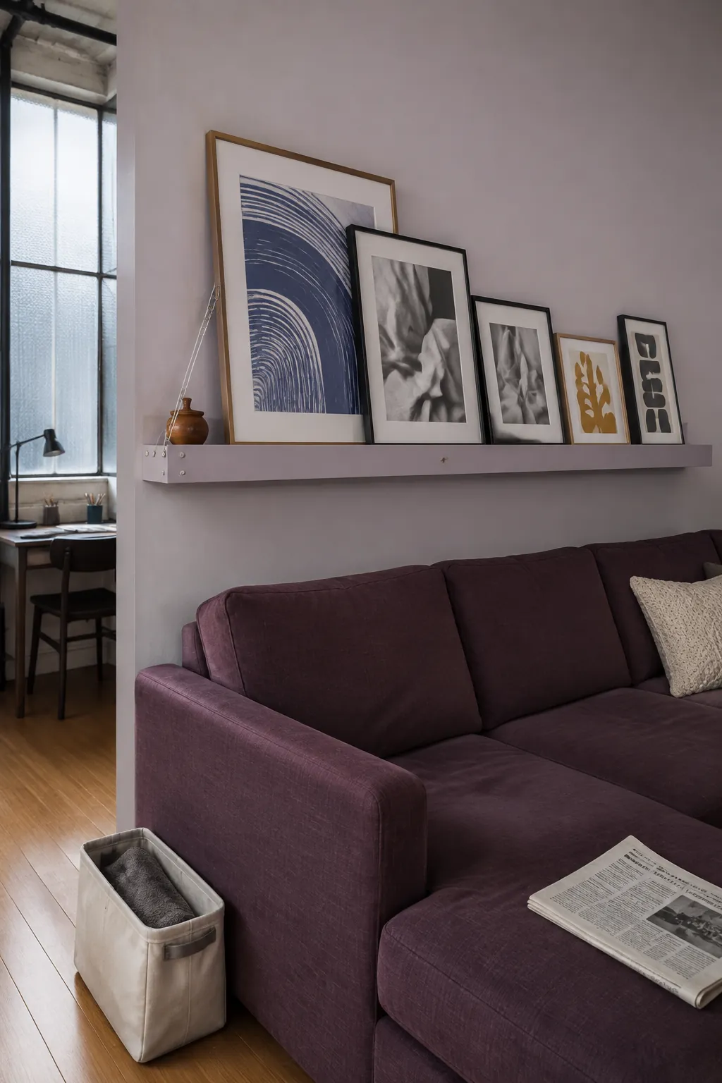 Long picture ledge with secure layered frames above a sectional