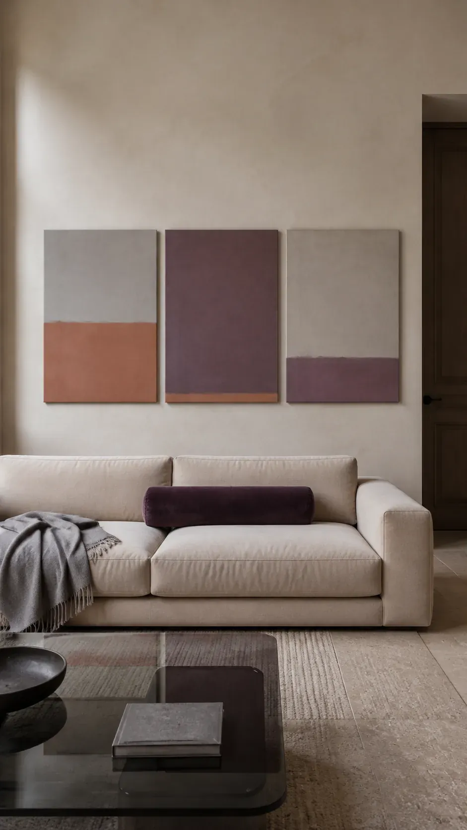 Muted color field triptych creating minimalist decor above a couch