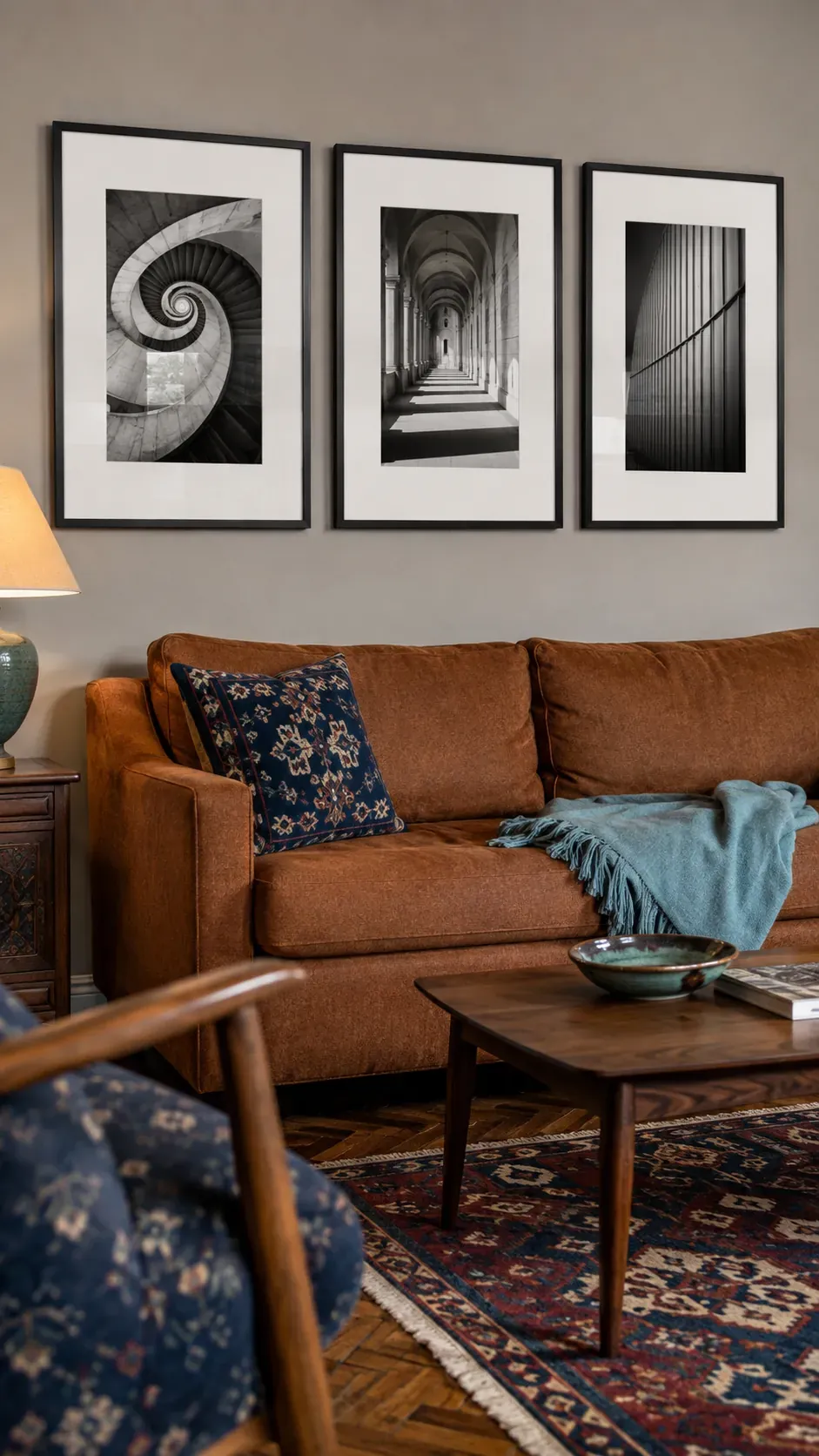 Three black and white architecture photographs above a sofa
