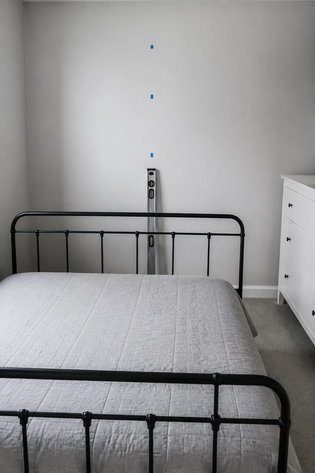 Bed center marked on a wall before positioning an arch decal