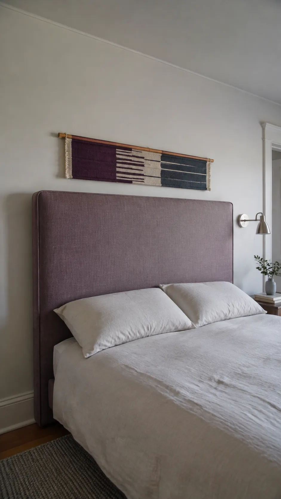 Shallow woven textile panel above a tall queen headboard