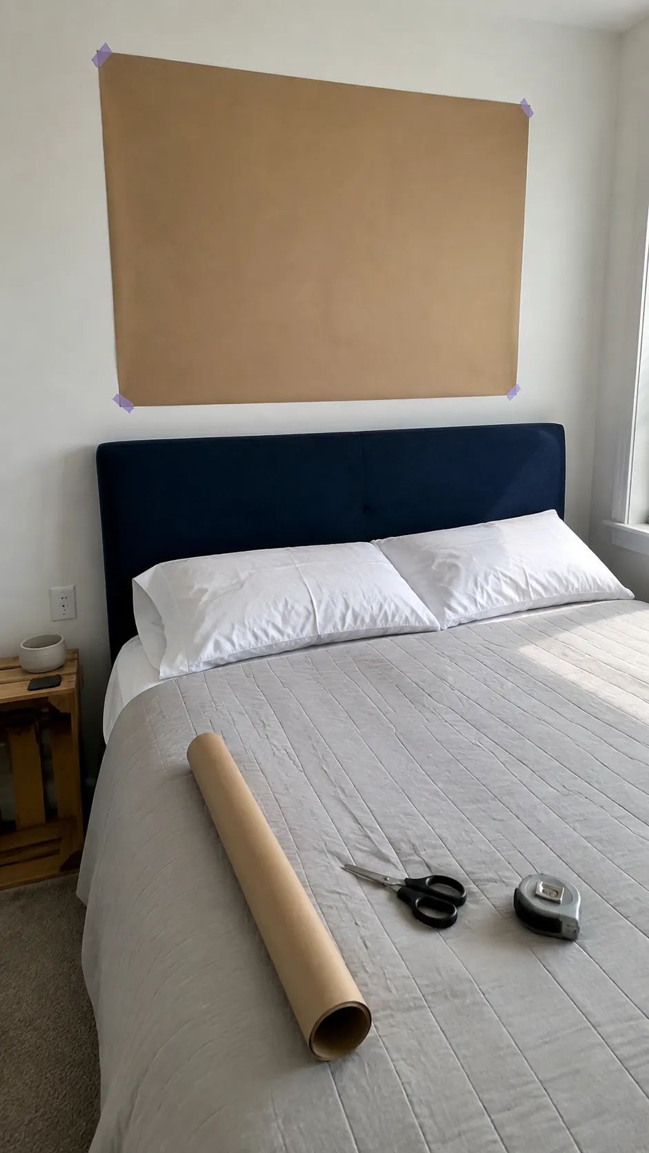 Paper sizing outline above a queen bed in a rental bedroom