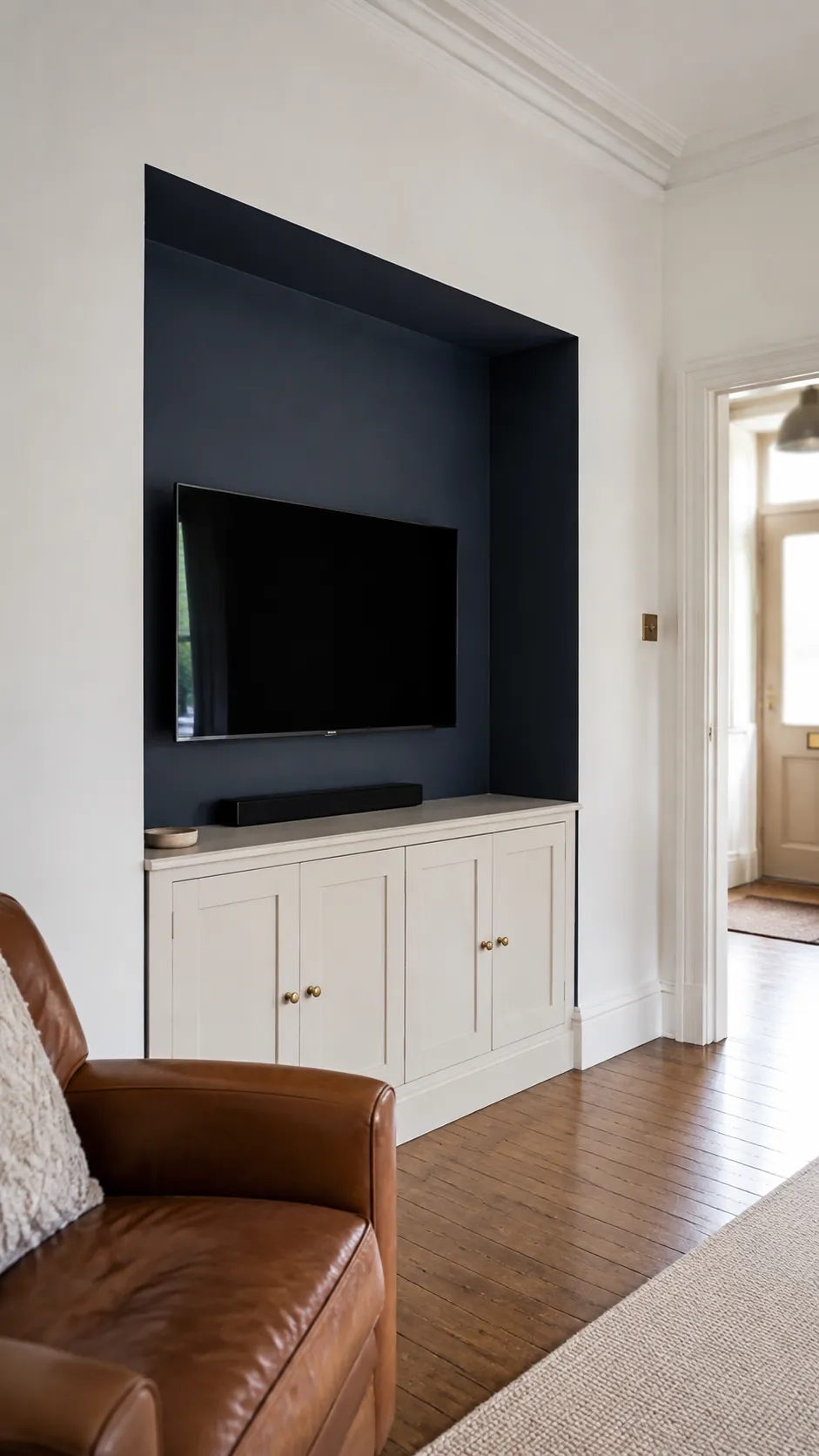 A deep navy alcove behind a television in a lived in room