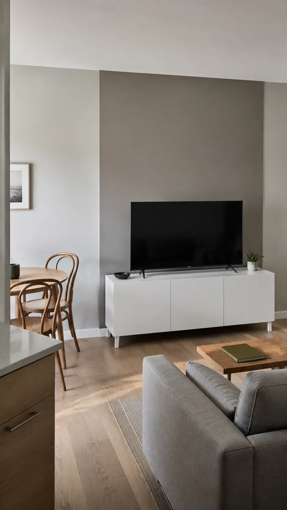 A broad painted color block behind a television in a lived in room