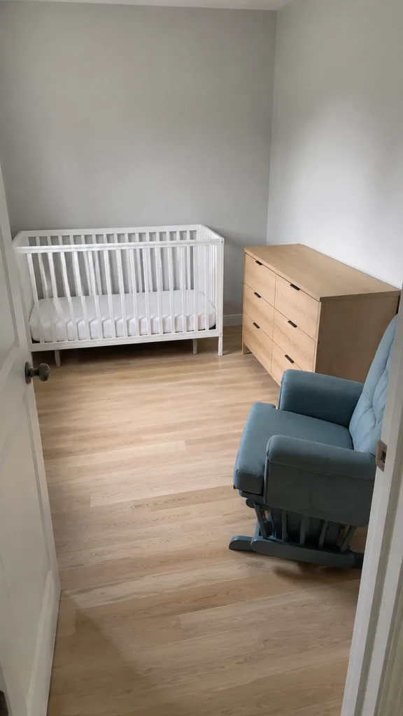 Compact nursery with crib dresser and glider around a clear central floor