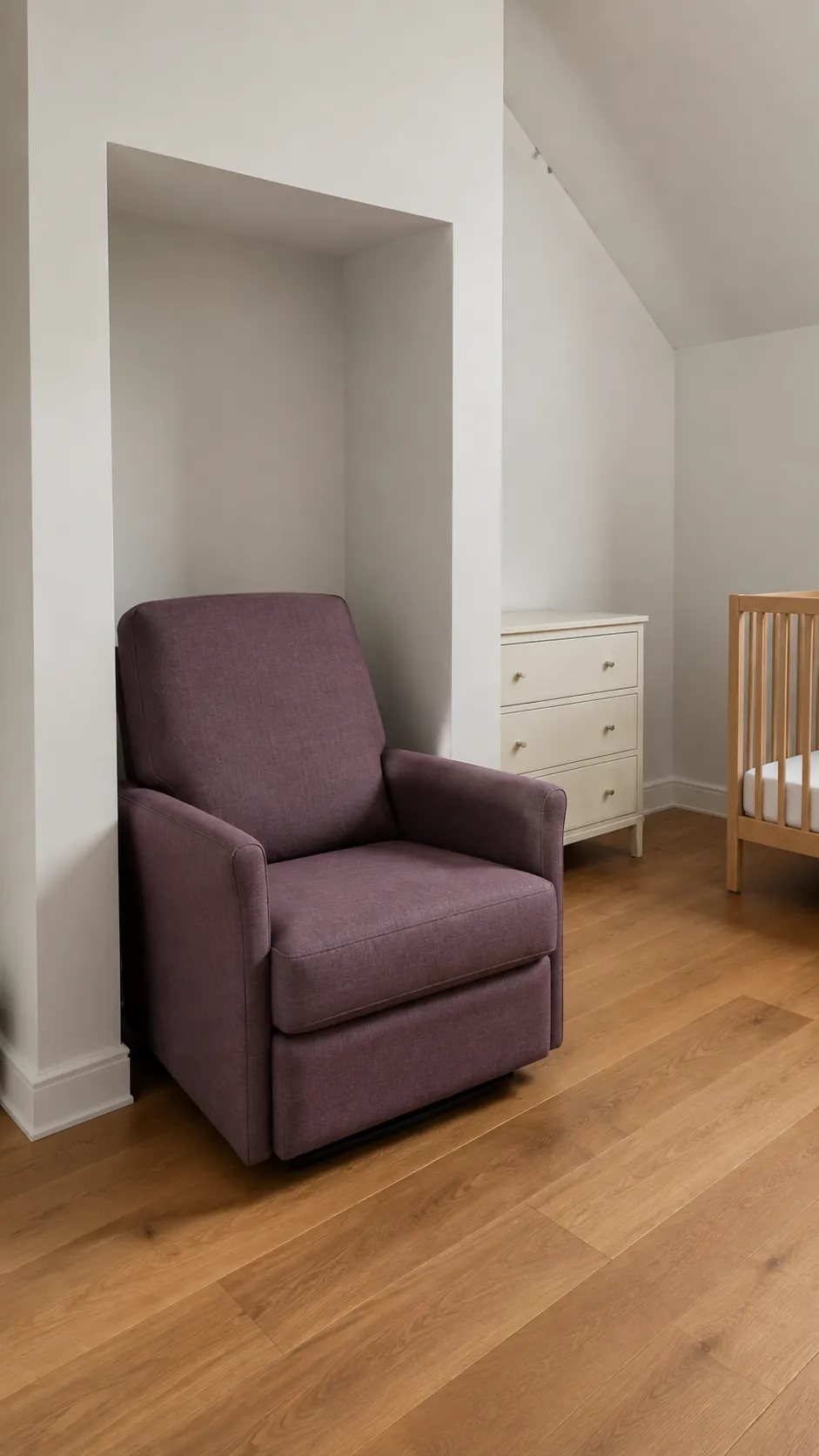 Show an alcove used for a compact glider while the crib and dresser stay on the main room walls