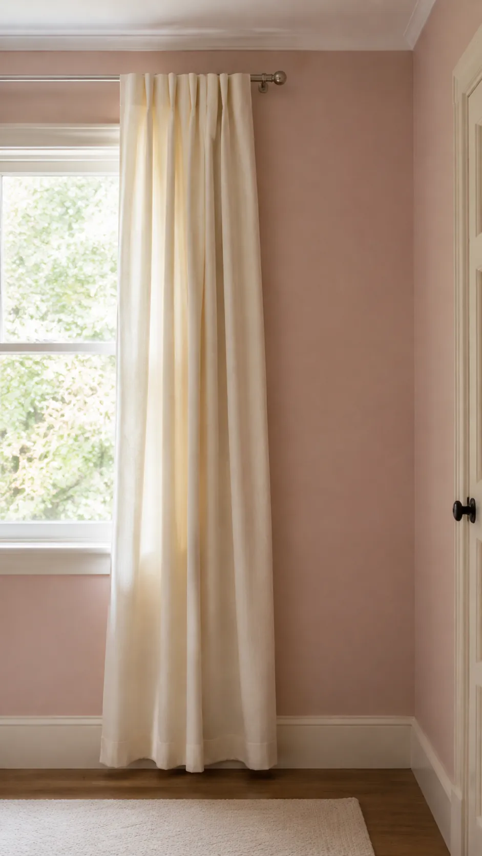 Let an ivory curtain soften a pink wall