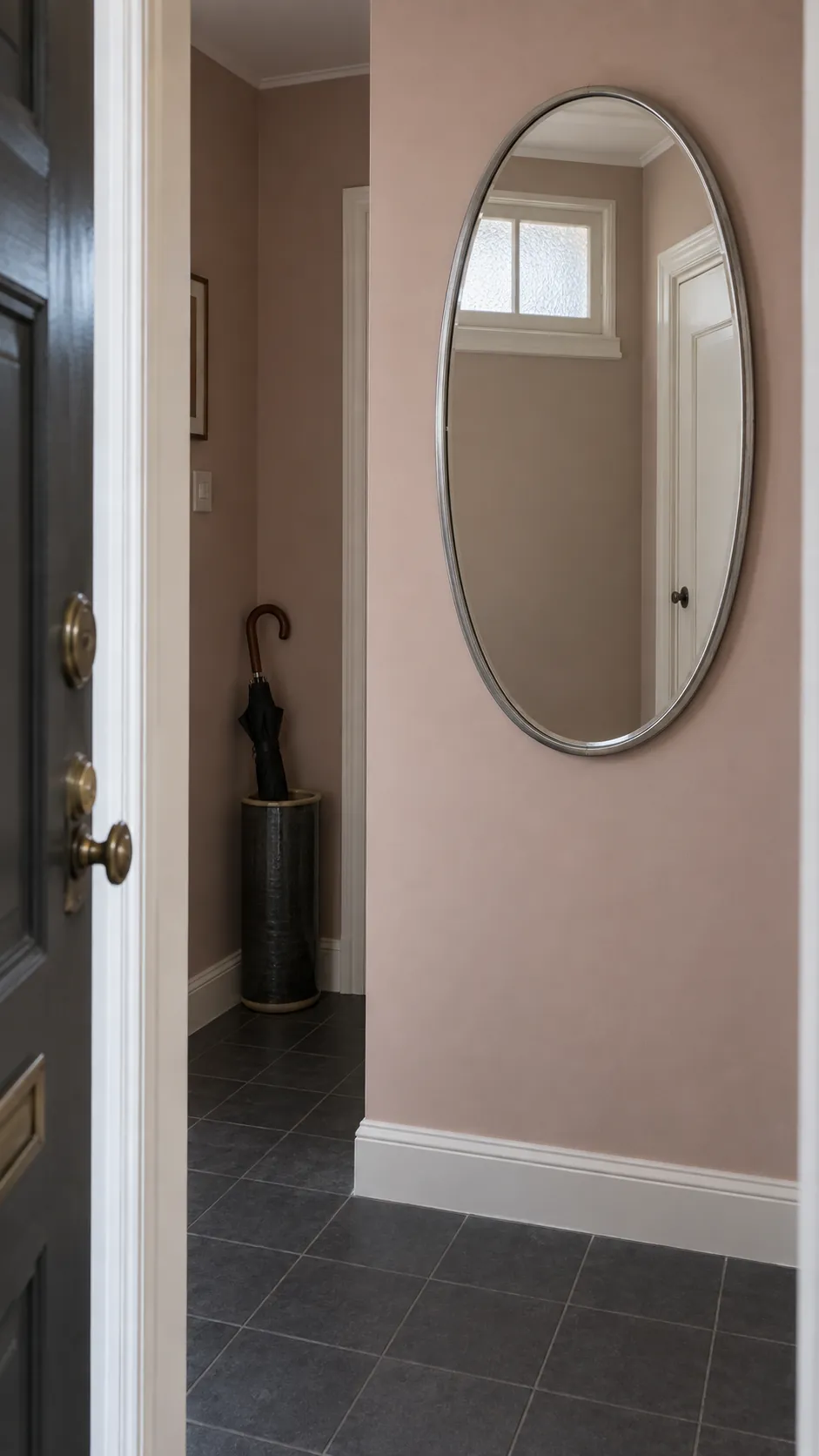 Create a photograph that explains useful mirror placement in a compact entrance, emphasizing a real standing position and an honest reflection