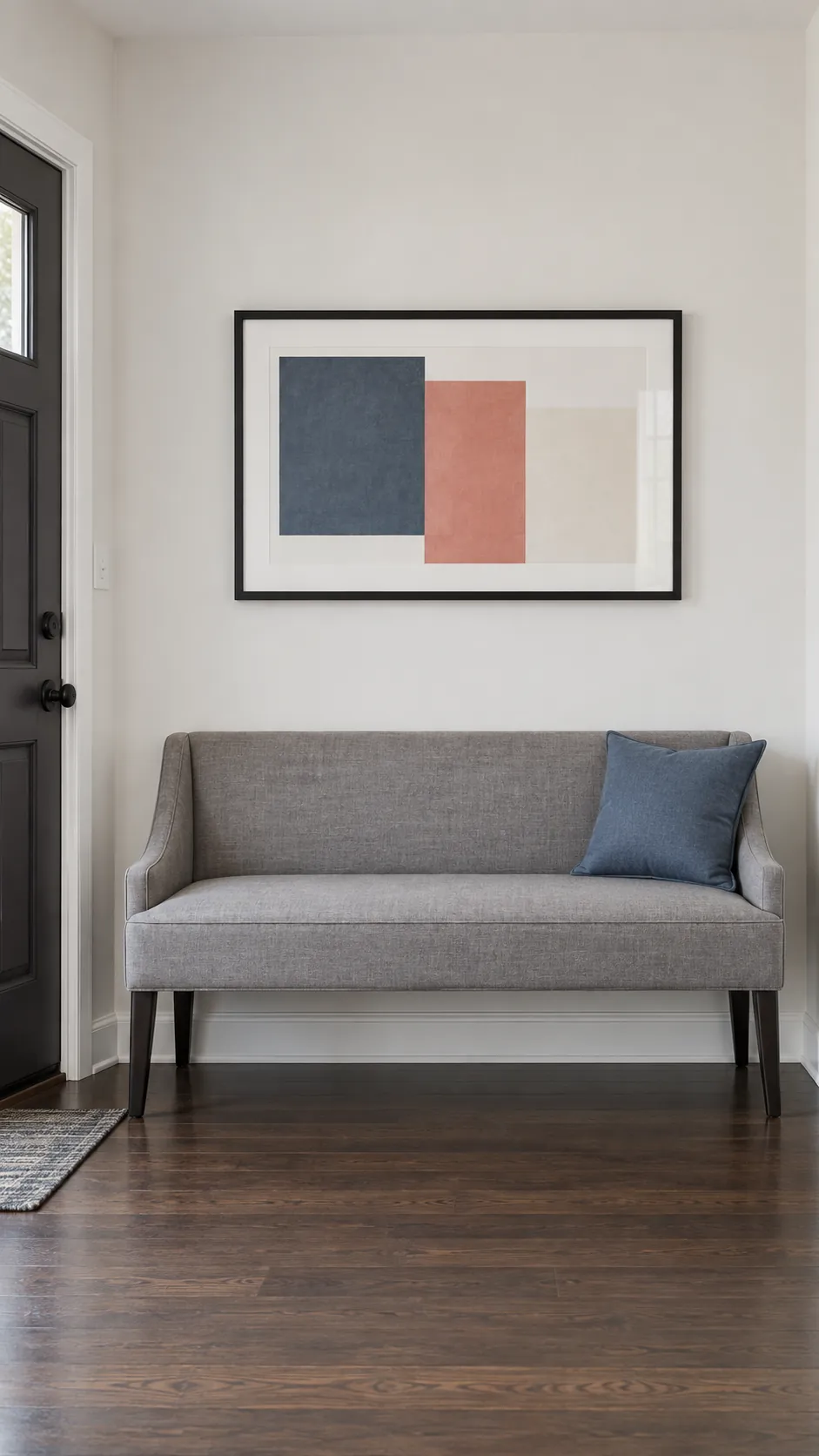 Photograph an entryway bench and a single proportionately sized horizontal abstract print as one calm arrangement