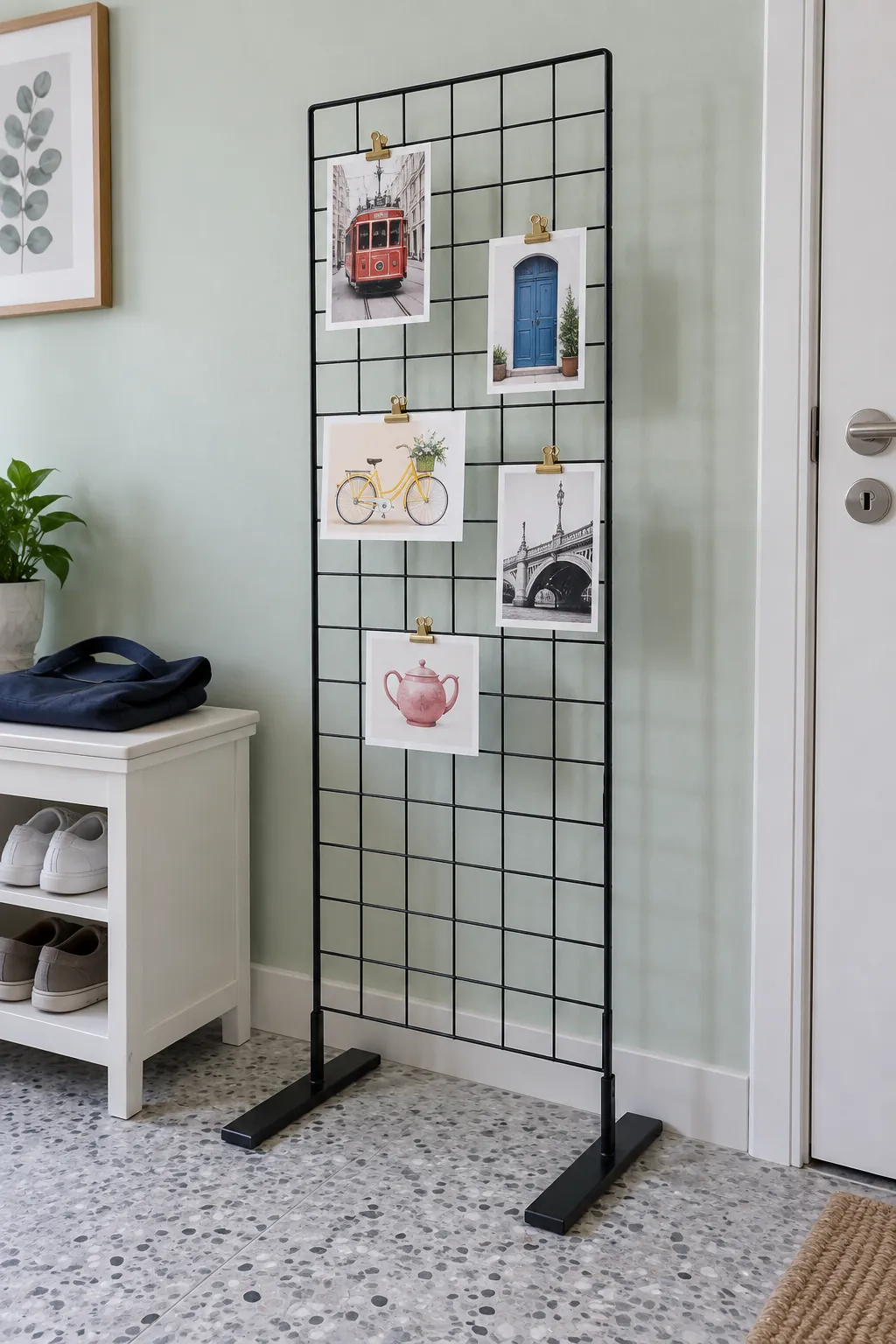 Postcards clipped to a stable freestanding wire display beside the entry