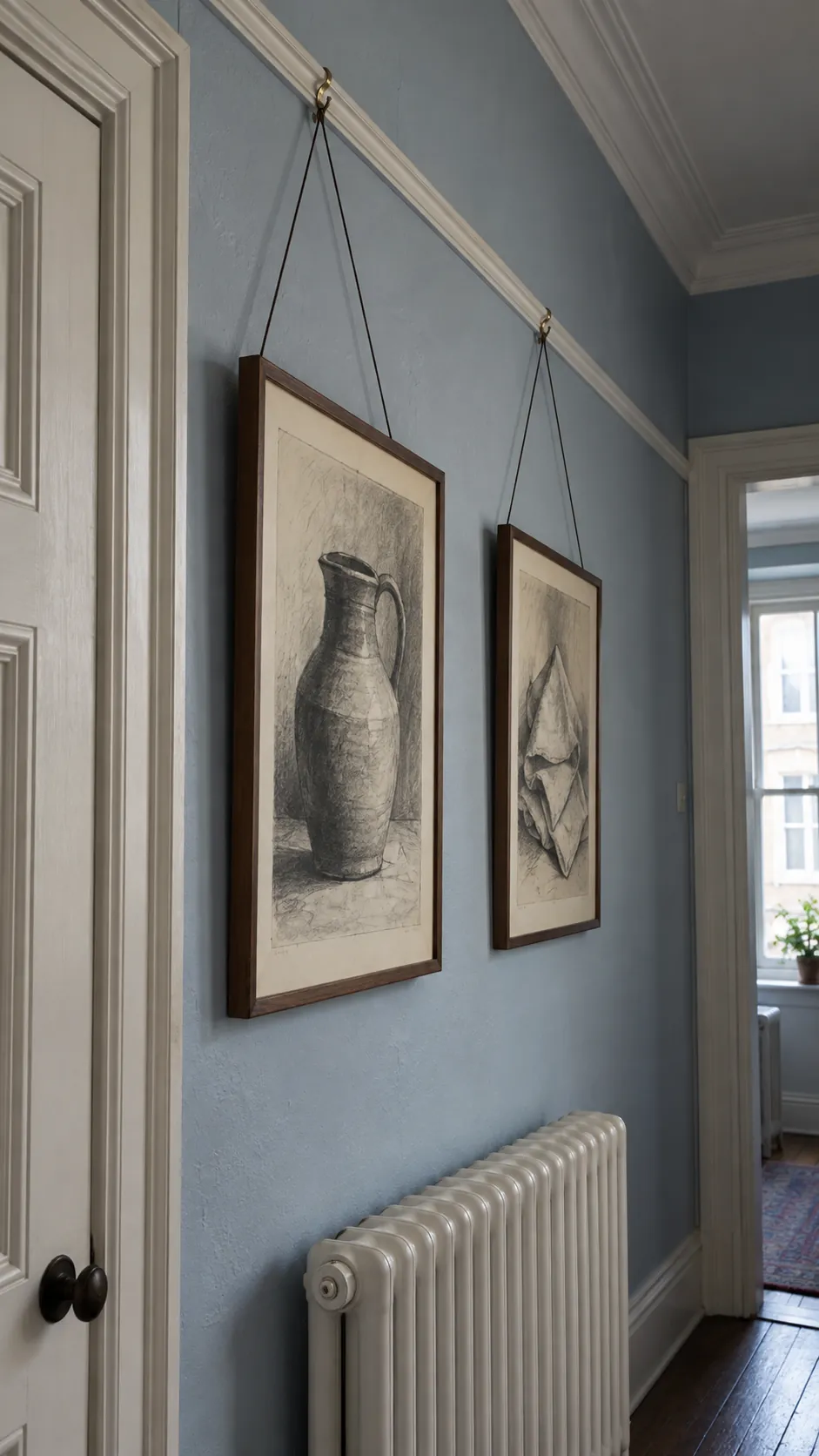 An existing picture rail with suspended drawings