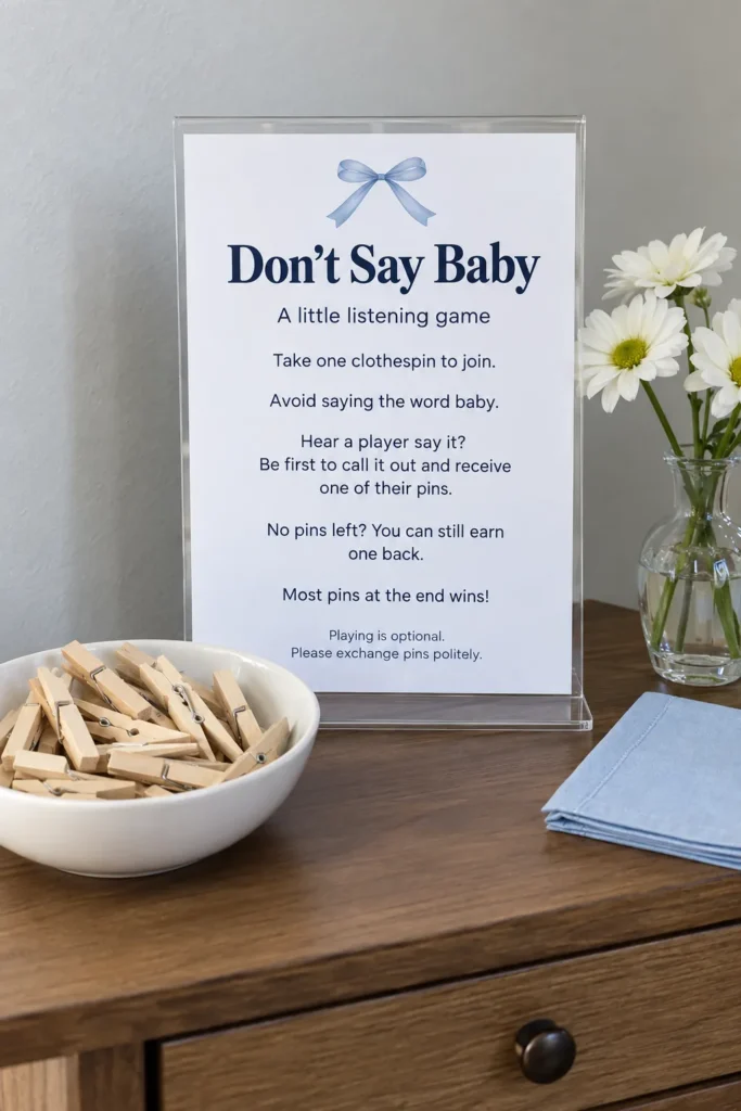 Don’t Say Baby sign and wooden clothespins on a welcome table